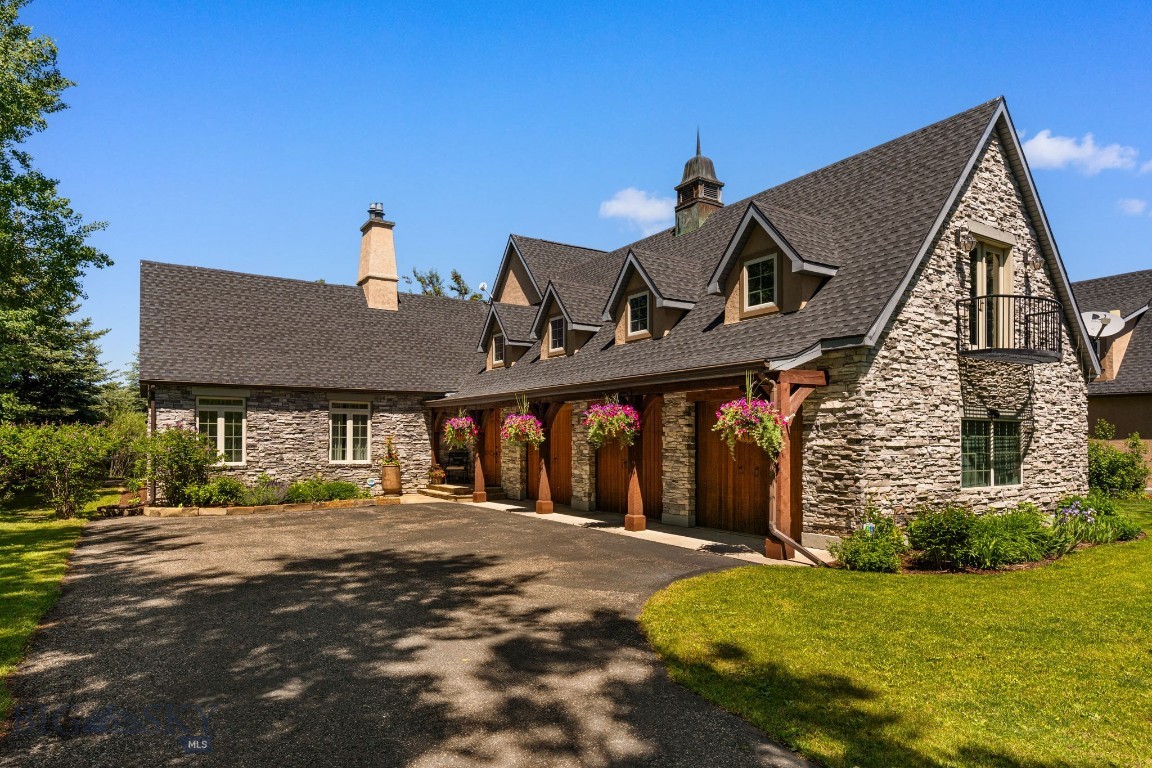 Welcome to one of Bozeman’s most inviting, luxury residences in the coveted Riverglen community. This beautifully maintained home offers warm, elevated finishes on a park-like setting that comes alive in the summer with mature aspens and vibrant landscaping. Set against 26.4 acres of public land and steps to the East Gallatin River, step inside your private entrance to a thoughtfully designed layout that lives like a single-family home. The main level features a grand living room with vaulted ceilings, hardwood floors, and a cozy gas fireplace, all framed by large windows that bring in natural light and views of the surrounding trees. The adjoining kitchen and dining area are ideal for both everyday living and entertaining, offering generous counter space, high-end stainless appliances, and seamless access to the patio for easy indoor–outdoor enjoyment. The main-level primary suite provides a spacious retreat with a walk-in closet, beautifully updated en-suite bathroom, and ample natural light. A laundry room, half bath, and direct entry to the three-car garage complete the main level. Upstairs, you will find two spacious bedrooms, a full bath, an airy loft with its own fireplace, plus an additional flex room perfect for a gym, hobby room, or home office. Thoughtful updates throughout the years include new HVAC, new roof, additional landscaping, updated tile and bathrooms, light fixtures, and closet buildouts, providing both style and function. The stone exterior, covered porch, and landscaped yard create a peaceful, established setting. The Riverglen community also enjoys sprawling dedicated open space and direct access to the East Gallatin River. Located just 8 minutes from the airport, and less than 10 minutes from bustling Downtown Bozeman, this home combines comfort, privacy, and exceptional convenience in one of North Bozeman’s most desirable areas.