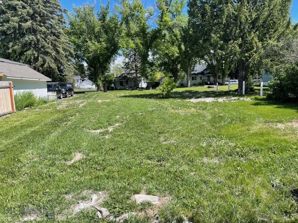 A RARE FIND! Nestled in Charming Manhatan Montana, this 7,000 square foot parcel with mature trees, perennial garden and heirloom roses beckons for your new home. These 2 city lots, with city water and sewer services available,  are in the original Manhattan plat created in the late 1800's when Railroad and Farming brought this little town to life. Walkable to wonderful restaurants, stores, banks and the town park, this gem is in the heart of it all!
