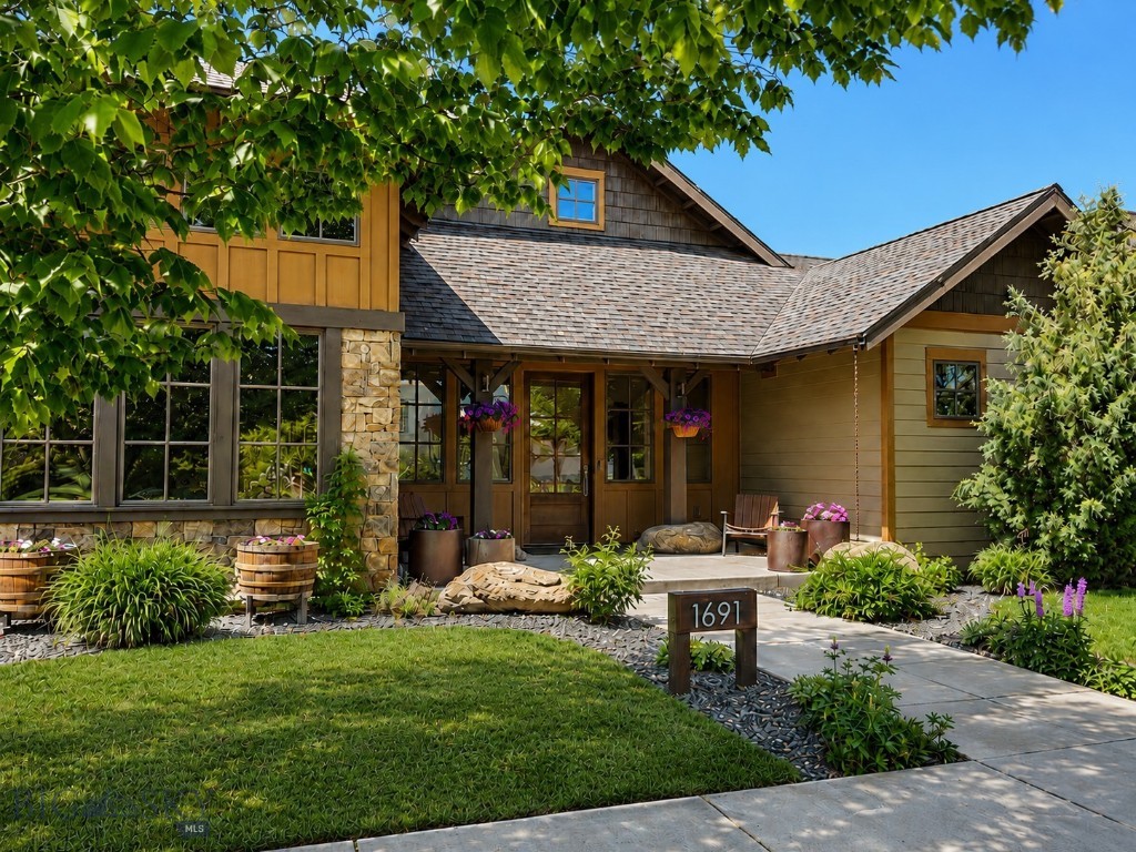 Nestled in the highly sought-after Legends at Bridger Creek community, this beautifully maintained 4-bedroom, 3-bath home offers 3,200 square feet of thoughtfully designed living space on a .243-acre lot with stunning views of the Bridger Mountains and Story Hills. Combining timeless craftsmanship, quality finishes, and exceptional outdoor living, this home captures the best of Bozeman living.

Inside, wide plank American Hickory floors, Andersen wood windows, stone accents, and Bosch appliances create a warm mountain-modern feel. The functional floor plan offers both privacy and flexibility, with the primary suite tucked privately on one side of the home while the additional bedrooms are situated on the opposite wing. A spacious upstairs bonus room provides additional living space, while the dedicated office features a large wall of windows and abundant natural light.

Designed for passive solar living, the home enjoys excellent winter sun exposure with limited summer heat intake. Additional features include two hot water heaters, ample storage, and an oversized attached two-car garage with one extra-long bay ideal for larger vehicles and gear.

Outdoor living shines with beautifully maintained landscaping featuring integrated irrigation, low-maintenance landscaping including mature trees, flowers, shrubs, garden beds, grape vines, apple trees and custom outdoor sculptures and trellis and an accessory storage shed.  The covered back patio is built for entertaining with gas outdoor fire feature and a gas line for BBQ.  Wood garage doors and low-maintenance exterior finishes complete the home’s exceptional curb appeal.

Located just minutes from Bridger Creek Golf Course, Story Mill Park, downtown Bozeman, trails, and Bridger Bowl Ski Area, Legends at Bridger Creek offers an unbeatable blend of recreation, convenience, and community.