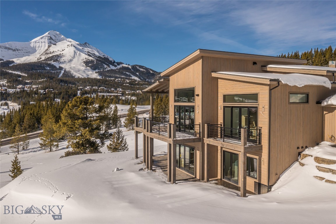 Set against the dramatic backdrop of Lone Peak and Andesite Mountain, 8 Washaki is a newly constructed luxury retreat designed to capture the very best of Big Sky living. Scheduled for completion in Spring 2026, this five-bedroom mountain residence offers a rare opportunity to secure a brand-new home in one of Montana’s most coveted alpine destinations.

From its elevated vantage point, the home is positioned to frame sweeping, unobstructed views of Lone Peak and Andesite Mountain—two of the most iconic peaks in the Northern Rockies. Expansive windows and thoughtfully designed outdoor living spaces invite year-round enjoyment, from bluebird ski days and glowing alpenglow sunsets to cool summer evenings beneath Montana’s wide-open skies.

Inside, the architecture reflects a sophisticated modern mountain aesthetic grounded in enduring craftsmanship and timeless materials. The five-bedroom layout is both functional and refined, offering generous proportions for everyday living and entertaining. Two distinct living rooms provide flexibility for hosting, multi-generational gatherings, or creating separate spaces for media and relaxation.

The primary suite and lower level are designed with spa-inspired amenities, featuring luxurious steam showers for both private retreat and shared wellness experiences—an ideal sanctuary after skiing, hiking, or biking. Open-concept living and dining areas anchor the main level, where natural light and curated finishes create an atmosphere that feels elevated yet inviting.

This new construction home at 8 Washaki pairs a premier location in Big Sky Mountain Village with a highly livable floor plan and beautifully executed interiors. Just moments from Big Sky Resort, residents enjoy world-class skiing, mountain biking, and hiking. One&Only Moonlight Basin, Big Sky Town Center, and the renowned Gallatin River are also a short drive away, offering dining, shopping, fly fishing, and year-round recreation.

Whether envisioned as a full-time residence, seasonal escape, or strategic investment property in Big Sky, Montana, this offering presents an exceptional opportunity to own a luxury home with panoramic mountain views and seamless access to the region’s most sought-after amenities.

For those seeking refined alpine living in Big Sky, 8 Washaki is ready to elevate what home in the mountains can be.
