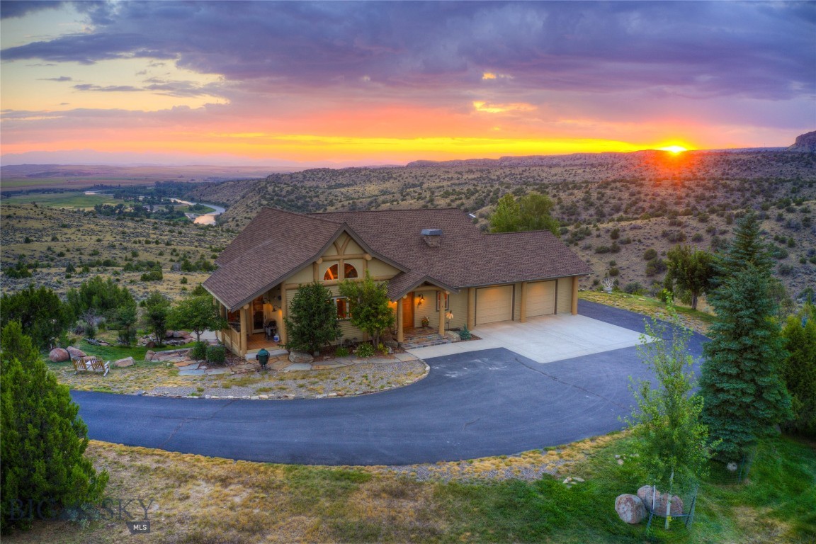Big Sky country on display right out your door! This lovingly cared for and well-maintained Gallatin River Ranch home is the perfect blend of privacy, comfort, and Montana beauty. Wake up every day to sweeping views of the Gallatin River and Tobacco Root Mountains, with abundant wildlife and endless skies filling your viewshed. Elk, mule deer, and others also call this piece of the west home. Watch as Mother Nature rolls storms across the
valley below and paints the river bottom from green in the spring to yellow and burnt orange in the fall. Set on a little over 19 acres, this parcel offers end of the road privacy. The home feels bright and welcoming with its open floor plan, vaulted ceilings, and large windows. The kitchen and great room are at the heart of this home, accommodating gatherings of any size. The main floor master is warm and inviting, with a well-appointed bath
and private access to the outdoor hot tub and sweeping westerly sunset views. The upper level offers options to fit your lifestyle as the fourth bedroom with full bath or a generous-sized home office. The walkout lower level offers two more bedrooms, a family room with wet bar perfect for gathering to watch the big game, and ample storage. The 8 foot sliders lead out to the patio adorned with a pergola and tranquil waterfall. This is one
of several outdoor spaces allowing you to enjoy your surroundings no matter the weather. Other impressive features include two gas fireplaces, exposed timbers, central air, and more. The 2024 built heated and air-conditioned shop with epoxy floor gives you room for projects, storage, and hobbies with two deep garage bays allowing for RV storage plus a flex space for a home office or gym. Gallatin River Ranch offers a multitude of
trails and roads to hike or bike, 2.5 miles of river access including a private boat landing, and a sense of community that makes you feel connected while still having our own quiet retreat. Set below, the charming town of Manhattan is just a short drive away and offers restaurants, a brewery, market, plus other amenities. The airport and all Bozeman has to offer is a short jaunt down the road. Come home today to 1061 Lookabout Lane!