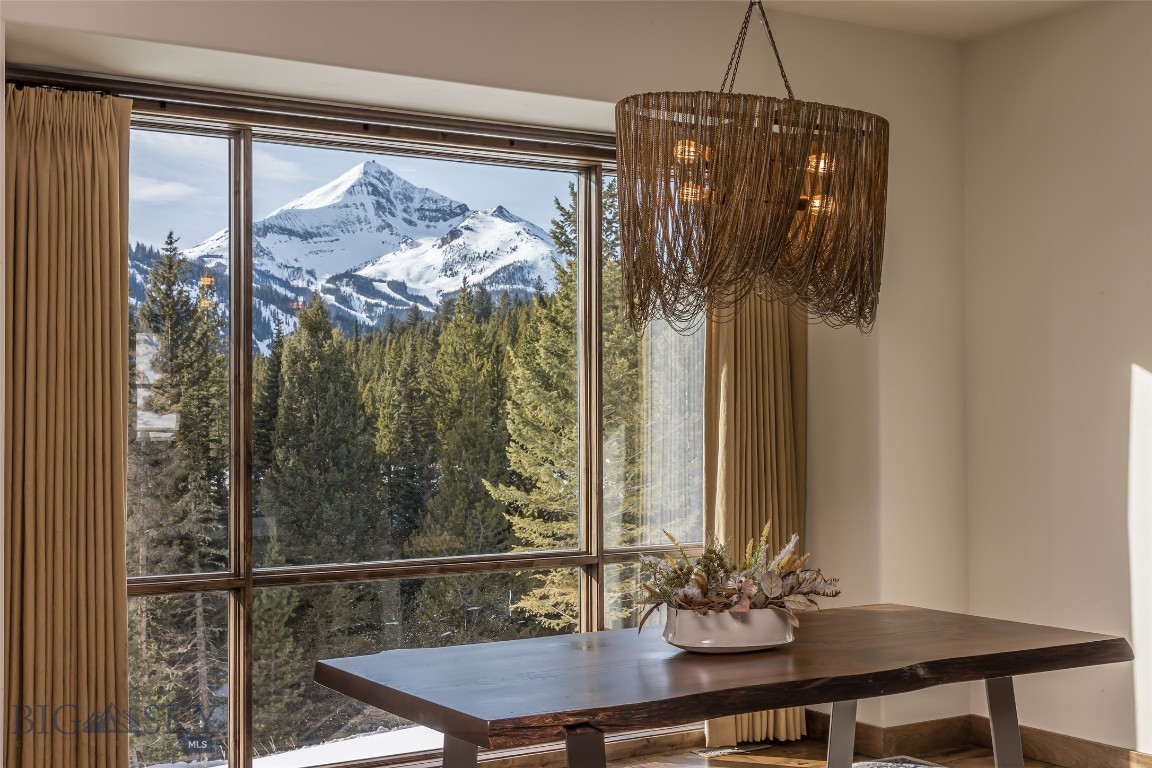 Set on 6.33 private acres in the coveted Big Sky Mountain area, just two miles from Big Sky Resort and world-class skiing, 172 Ciel Drive is an exceptional alpine retreat offering rare privacy, refined custom craftsmanship, and stunning unobstructed views — all with no HOA and zoning in place for a future guest home. Surrounded by mature forest and mountain scenery, this exclusive property captures the essence of Montana living in one of the region’s most sought-after settings. 

Built in 2018, the residence spans 3,868 square feet and features a two-car garage, five bedrooms, three full bathrooms, one powder room and 2 fireplaces. Designed to balance timeless mountain architecture with modern luxury, the main level showcases an open-concept great room anchored by a dramatic stone fireplace and exposed beam ceilings — ideal for gathering and entertaining. The chef’s kitchen features an expansive island with seating, custom cabinetry, professional-grade appliances, generous prep space, and hand-placed stone accents, with abundant natural light and spectacular mountain views. The main-level primary suite offers a private sanctuary complete with its own fireplace, custom built-ins, and a spa-inspired bath featuring dual vanities, custom stonework, a walk-in steam shower, and a soaking tub positioned beneath picture windows. The walk-out lower level provides exceptional flexibility with a spacious family and recreation lounge, an additional fireplace, a custom wet bar with wine storage, built-in shelving, and guest accommodations well-suited for extended stays. A thoughtfully designed mudroom adds everyday functionality with ample storage and a dedicated dog wash station. Outdoor living is equally inviting, with covered deck and patio spaces for year-round enjoyment, along with a fire pit area surrounded by Adirondack seating — perfect for evenings beneath the Big Sky stars. 

A defining feature of the property is its rare future expansion opportunity. Approvals are already in place through the Gallatin City–County Health Department and Montana DEQ for a future guest house. A separately constructed access road provides an ideal private approach for the additional guest residence, enhancing long-term value and flexibility. Private acreage, close proximity to skiing, and the ability to expand in such a premier location are rare. 172 Ciel Drive represents a true legacy Big Sky offering.