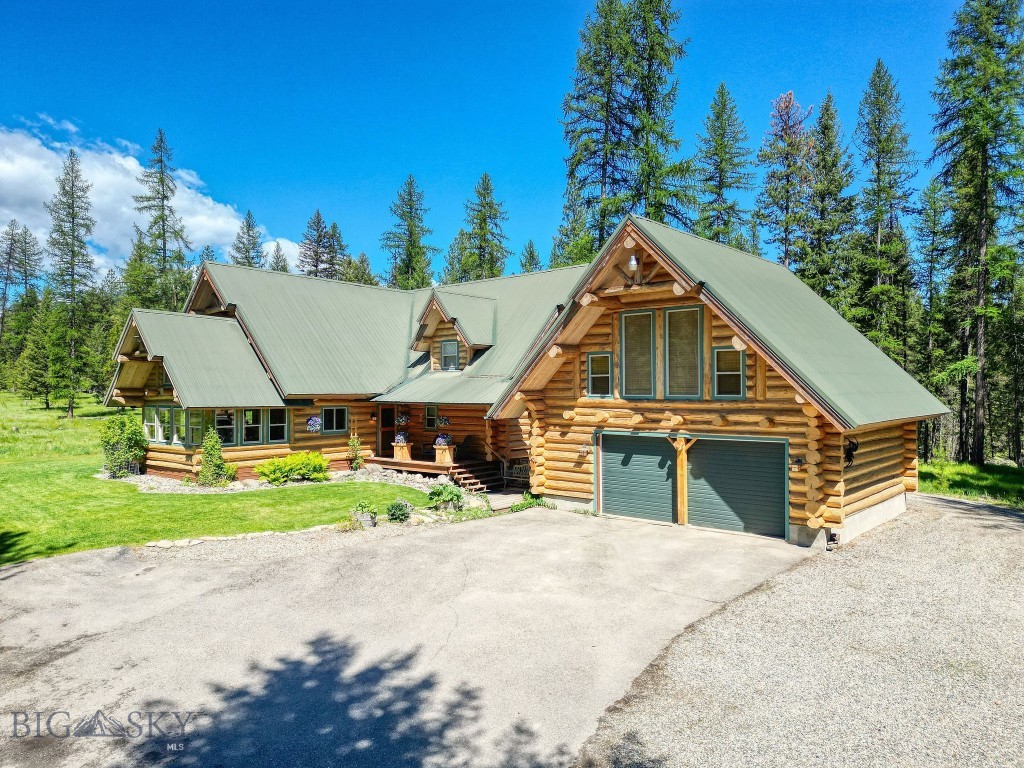 Experience true Montana privacy with this 2 Bed/ 2.5 Bath home set on a breathtaking 40-acre parcel entirely surrounded by Kootenai National Forest. With the closest neighbor over a mile away, this property offers unmatched seclusion only minutes from town & easily accessible from the highway & small airport. Inside the pride of ownership shines throughout. Custom cabinetry, and built-ins made from lumber harvested from the property are seen throughout. Large picture windows frame the stunning views & fill the home with light. Watch wildlife from the living room windows year around. The open floor plan provides comfortable living/entertaining space, with laundry, bathrooms & the primary suite conveniently located on the main floor. The property includes older buildings with another septic & services that could serve as the perfect building spot for a multi-generational living arrangement or future development. This exceptional property is truly a must see!

Deer, elk, moose, and bear are among the abundant visitors here. The nearby Kootenai river offers world class, blue ribbon trout fishing. Lake Kookanusa is famous for its water-sport recreation and beautiful bays. The unfinished basement offers abundant storage and the potential to expand your living space to suit your needs. The logs for the home are from Great Slave Lake in Canada and hand-peeled and built by a local Libby craftsman and builder. Above the garage, a generous bonus area creates endless possibilities as a game room, creative/ hobby space, or home office.