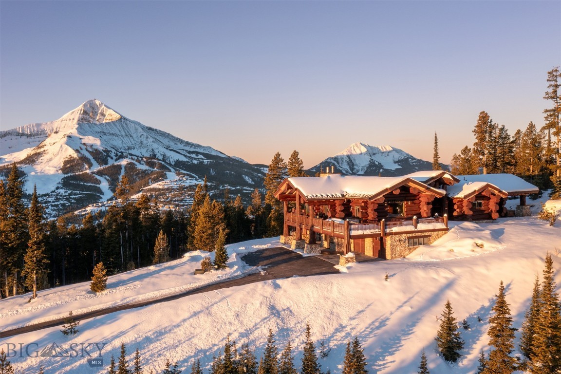 Set behind a private gate in the pristine Ridgeview Loop neighborhood of Beehive Basin, this one-of-a-kind luxury retreat offers the rare combination of privacy, dramatic scenery, and convenient access to Big Sky’s renowned mountain amenities. Positioned on twenty private acres, the home delivers an elevated, “top of the world” feel with sweeping 360-degree views from nearly every room.  Unobstructed vistas frame Lone Mountain most prominently, with Wilson Peak, Fan Mountain, Pioneer Mountain, and other surrounding landmarks adding to the remarkable alpine panorama. The property is close to the popular Beehive Basin trailhead and access to Beehive Lake, creating an ideal base for year-round recreation while maintaining a peaceful sense of seclusion.  The home evokes the warmth and character of a classic mountain lodge, with massive log, timber, and stone features throughout. A wraparound deck with an outdoor fireplace expands the living space into the landscape, while thoughtful amenities—including an elevator, sauna, and hot tub—enhance comfort and convenience.  Plans are also included for an additional guest home that is allowed to be built on the property, offering flexibility for future use and entertainment.  This home has had one owner, has been meticulously cared for, is being offered unfurnished with appliances, and is just minutes from skiing at Big Sky Resort and Moonlight Basin, fishing and whitewater rafting on the Gallatin River, and within easy driving distance of Yellowstone National Park and Bozeman. It is a truly special offering in one of Montana’s most sought-after mountain resort communities.