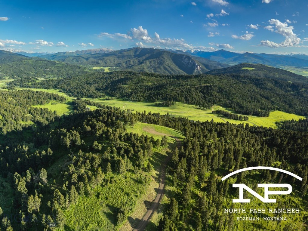Welcome to North Pass Ranches, Bozeman’s newest gated, luxury ranch community. Parcel 3 boasts an expansive view of the Gallatin Valley and the Bridger range, as well as jaw-dropping vistas of the Absarokas, Hyalite Peak, the Spanish Peaks, and the Tobacco Roots. The overall setting is both grand and historic in feel, and lends itself well to a stately main home and guest residence. Parcel 3 also boasts direct access to State Land, offering miles of hunting, hiking, and recreational opportunities, as well as securing the privacy of the site. With paved roads all the
way from Bozeman, wells and power in to all of the homesites, these panoramic retreats are truly build-ready. The ranch is comprised of over 1,500 acres of awe-inspiring views, lush meadows, and pure mountain air, creating an idyllic community situated just 15 minutes from Downtown Bozeman, yet feels like the secluded mountain oasis Montana dreams are made of. Thoughtful amenities on site include a full time ranch manager, stocked ponds for fishing and casting lessons, over 10 miles of developed horseback riding and hiking trails, plus abundant wildlife in
every corridor - elk, moose, deer, and bear abound. An excellent confluence of accessibility and privacy.