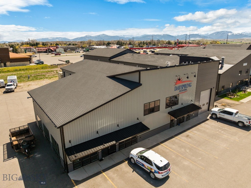 Great multi purpose building in great location just one block from Four Corners.  This building has a great mix of everything you could need for multiple purposes.  There is nearly 5,000 square feet of shop space with seven overhead doors.  Over 2,000 square feet of open nicely finished ground floor space for retail, showroom, open work space, etc.  There is a welcoming reception area, and upstairs is an additional 1,750 square feet of large offices.  Come walk through this immaculate building and see the possibilities!