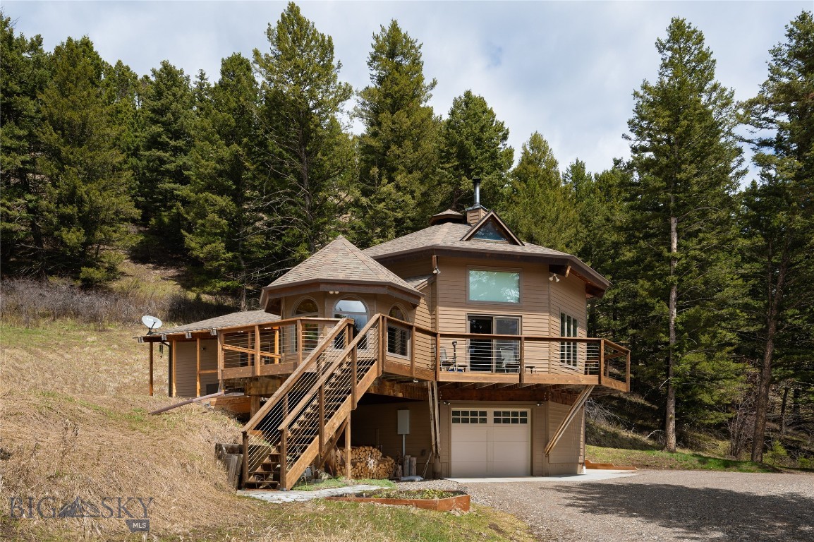 This is Montana living at its finest! Discover the perfect blend of refined craftsmanship and breathtaking natural beauty at this uniquely perfect property located in Park County with a Bozeman address, this home with guest cabin and extra shop could make a perfect vacation rental retreat. Expertly remodeled by esteemed custom home builder Keith Fraser, this stunning property offers a rare opportunity to own a true Montana retreat — complete with a main home, guest cabin, shop, and 16 sun-drenched, south-facing, sunny acres teeming with abundant wildlife. The main home is a masterpiece of quality and comfort, featuring an open-concept, soaring ceiling, and a bonus sleeping loft space with custom wood plank flooring, pretty cabinetry, and intricate carpentry throughout. Large windows frame sweeping views of the surrounding landscape and wildlife while Quinn Creek itself, meanders through the lower section of the property. Whether you're relaxing on the expansive deck, spotting deer and elk from your window, or exploring your own stretch of creek side paradise, this property invites you to live fully immersed in living the true Montana dream. Features that must surely go un-noticed include a quaint guest house for visitors or rental income, a detached shop (equipped with a loft that has a separate entrance,) year round accessibility for full-time living or an all-seasons get away, and sweeping southern exposure offering natural light that is usually hard to find in mountain homes. Every corner and nook of this home has a custom feature that simply provides the WOW factor. The property is EASILY accessible year round and sits right between the infamous Bozeman and the Legendary Livingston Montana. This home has been treasured, is beyond well kept and has been filled for years with love. Whether seeking a private escape, a family compound, or a FOREVER home, the property offers unmatched beauty, craftsmanship, and lifestyle. Make this your HOME SWEET MONTANA DREAM HOME!