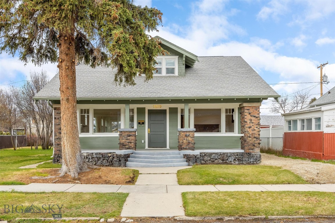 Charming 1920 Craftsman, beautifully updated while preserving its original character. This two-story home features three spacious bedrooms and three newly tiled bathrooms, along with a very light and bright redesigned open floor plan. The expanded kitchen offers new cabinetry, countertops, flooring, windows, a gas stove, ad more, perfect for both everyday living and entertaining. The inviting main living area includes a cozy gas fireplace, dedicated dining space, and a charming parlor showcasing an original player piano. The primary suite is conveniently located on the main floor for added comfort and accessibility. Additional highlights include a large basement with abundant storage, refinished original white oak flooring, new plumbing and electrical, recessed lighting and fresh interior and exterior paint throughout. Enjoy outdoor lving on the spacious front porch or take advantage of the generous 8,015 sq ft lot featuring a large side yard and a detached single-car garage with an extended driveway. Ideally located close to town and the elementary school, this home offers timeless charm with modern updates in a highly desirable setting.