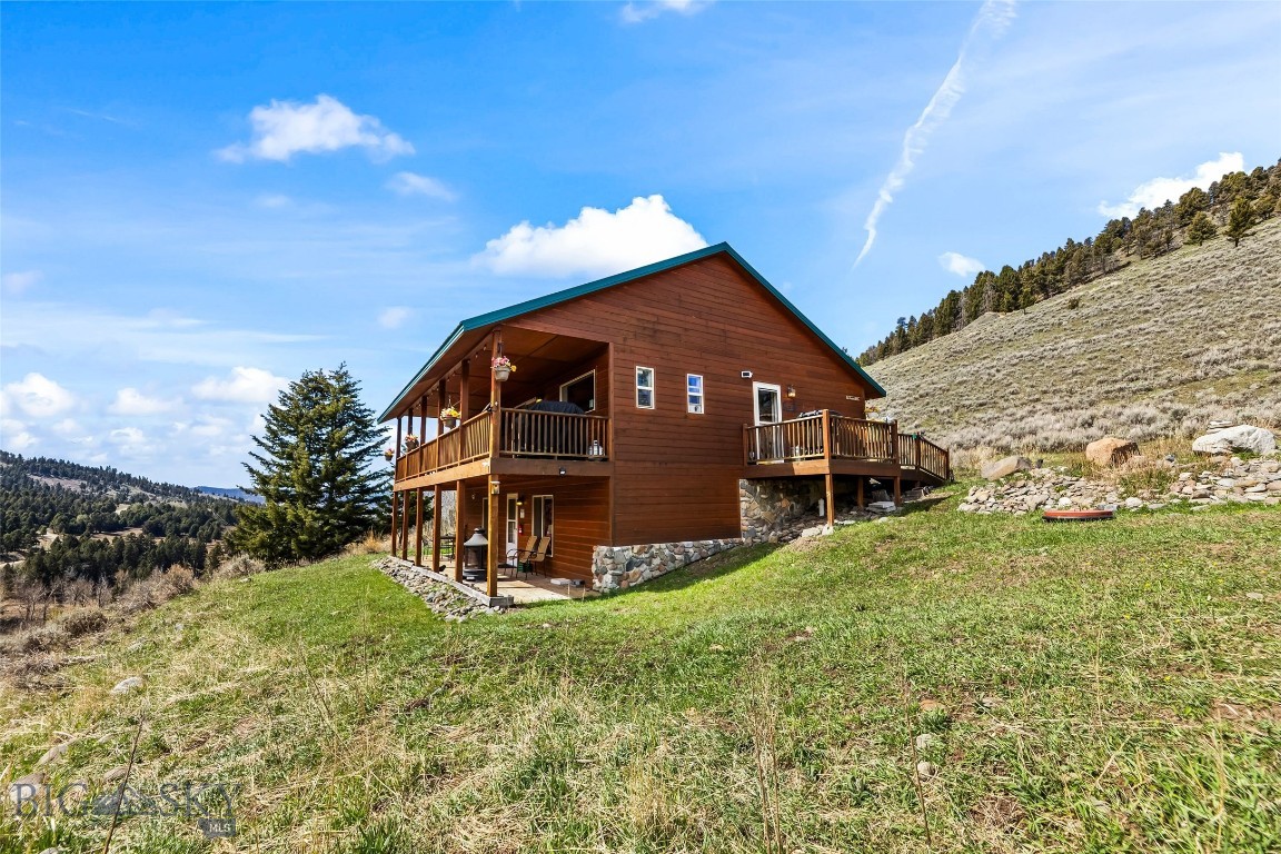 Views, views and more views from this mid-mountain home only 6.5 Miles from Yellowstone National Park. Unwind from city life in the mountains with the security of knowing there are neighbors close by. This property borders the 2 million acre Gallatin National Forest, which is rich in wildlife, scenic alpine vistas, rugged wildlands, and a spectrum of recreation opportunities. This is truly a paradise for big game hunters, photographers, nature lovers and more! Located on 1.87 Acres, this beautiful 3 bed 3 bath home is well maintained with an open concept. The main floor has a primary bedroom/full bath, Guest Bedroom, Guest Hall Bath, Modern Kitchen, Dining area and Living room with loads of natural light. The lower level has a walkout basement to a covered patio, Family Room, the 3rd bedroom, full bath/laundry area. Enjoy the sounds of Bear Creek burbling down below or look out from under the covered deck to old time history of the Jardine gold mine in the distance. Also horseback riding and backcountry trips with nearby outfitters. This can be a year round residence or a vacation home. Feel like you're miles from the city overlooking the small unincorporated community of Jardine. Just 6 miles to the popular tourist town of Gardiner and to the North, only year-round entrance to Yellowstone National Park. Currently a profitable vacation rental that, in the peak of summer can bring as much as $20K in bookings in one month! Schedule a showing today