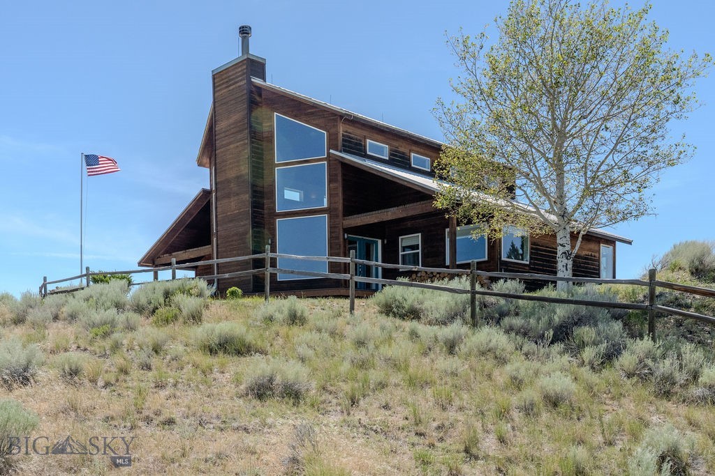 Perched above the Beaverhead Valley approximately 9 miles south of Twin Bridges, Seven Ranges Ranch is a remarkable 77.22± acre Montana property offering panoramic views of seven mountain ranges, exceptional privacy, and a rare combination of aviation, equestrian, and recreational amenities. A conservation easement bordering the western boundary helps preserve the area's open-space character and protect the surrounding views.

The ranch is anchored by a custom home offering just under 2,000 square feet of living space plus a loft area. Expansive windows capture the surrounding scenery, while exposed wood beams, slate flooring, and a floor-to-ceiling wood-burning fireplace create a comfortable Montana atmosphere. The primary suite includes a tiled walk-in shower, jetted soaking tub, and double vanity. Additional features include central heat, fiber optic internet, reverse osmosis, water softener, updated appliances, and an oversized heated and insulated two-car garage.

Outdoor living is enhanced by approximately 750 square feet of covered decks and porches, including a premium new deck completed in 2025.

Aviation enthusiasts will appreciate the private runway and insulated, heated airplane hangar equipped with a Higher Power hangar door system. Additional improvements include a heated and insulated shop with electric radiant heat and a well-appointed apartment above, providing flexible guest or caretaker accommodations. Both the residence and apartment are served by permitted septic systems.

Equestrian facilities include fenced pastures and a barn. The property also features dedicated rifle and pistol shooting ranges, including a purpose-built rifle shooting structure. Deer and antelope are frequent visitors.

The Beaverhead, Big Hole, Ruby, and Jefferson Rivers are nearby, providing outstanding trout fishing opportunities. Extensive public lands throughout the Beaverhead-Deer Lodge National Forest and surrounding mountain ranges offer exceptional hunting, hiking, horseback riding, camping, and ATV recreation. Yellowstone National Park is approximately 90 minutes away.

With mountain views, private aviation infrastructure, quality improvements, horse facilities, shooting ranges, abundant wildlife, and no covenants, Seven Ranges Ranch presents a rare Montana ownership opportunity.