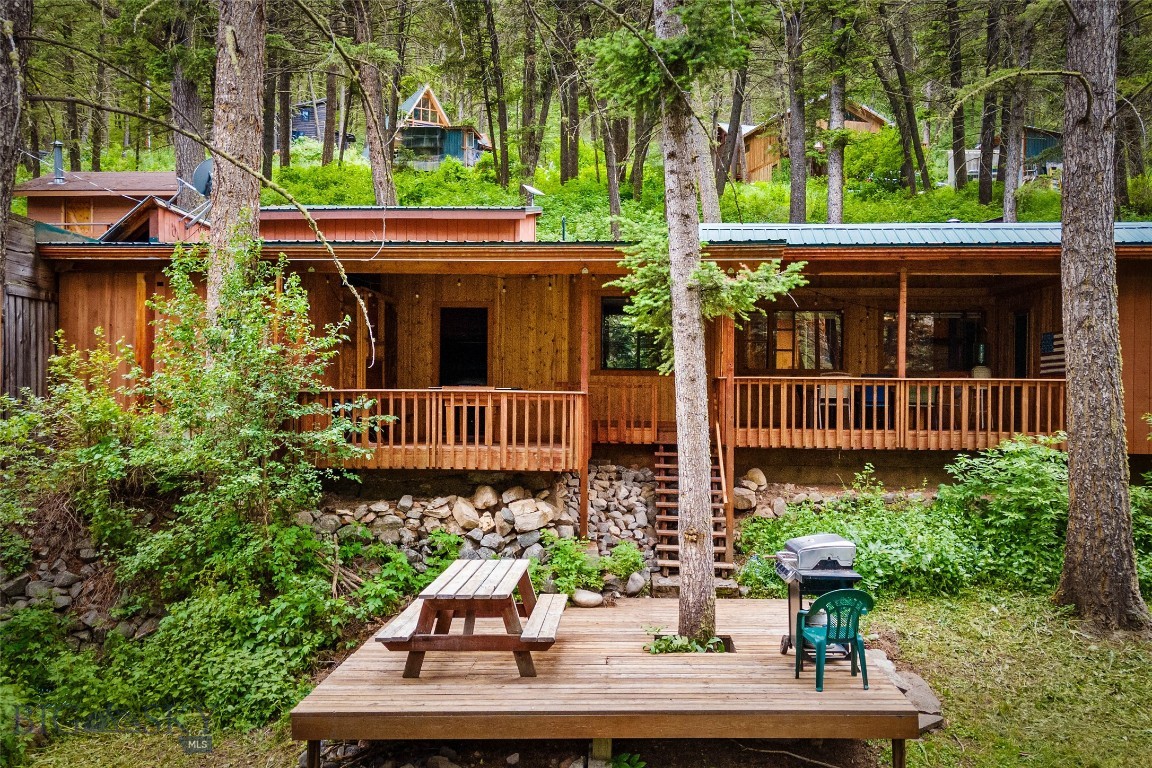 If you're looking for a quintessential Montana adventure, then THIS is YOUR property. Tucked into a piney hillside, across the road from the Gallatin River and just beyond the shadow of Storm Castle Peak, this location is spectacular: Big Sky is 25 minutes up the canyon, and Bozeman is 35 minutes to the north. Plus the Gallatin National Forest pretty much surrounds the place with its endless miles of hiking trails, mountain lakes to explore, fishing, rafting, and more. Here's the basic info on the buildings: MAIN HOME: 3 bedrooms, 2 baths, kitchen, dining area, cozy living room with wood burning stove, and lots of deck and patio space. CABIN: 1 bed, 1 bath, kitchen, equally cozy living room with wood stove, loft for extra sleeping space, and wrap around deck. BUNK HOUSE: 2 bunk beds, a fridge, wood stove, and small deck. What it lacks in water (there's none, so no bathroom) it makes up for it with historic charm. DETACHED GARAGE: 2 doors, one tall RV door, plenty of storage space and an unfinished loft above. This would make the perfect gathering place for family & friends, or a great vacation rental. There's lots to unpack and the description & photos can only do so much, so call for your private tour. You'll fall in love once you see it in person. This property is back on the market at a greatly reduced price!