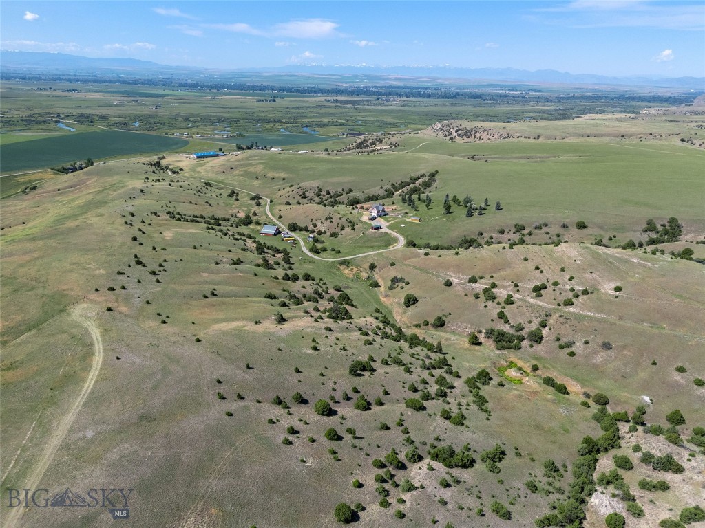 Set on 140± acres of open rangeland northwest of Belgrade, Hidden Spring Hills offers a rare chance to own a vast and unspoiled piece of the Gallatin Valley—an increasingly scarce opportunity in a region undergoing rapid development. This land is the main event: wide horizons, unobstructed mountain views, and a quiet that speaks to what Montana once was. Minimal covenants. No HOA. No commercial encroachment. Just space, sky, and possibility.
Beautiful rolling acreage with water rights (a 350 gpm irrigation well stands ready for a future owner to put water to work) and southern exposures offers pasture land for horses and livestock as well as space for all of your recreational needs– horseback riding through sunlit meadows, hiking hidden trails, sledding down snow-covered hills, cross-country skiing, or quietly observing the rhythm of wildlife in every season. Develop your own trails or follow the game trails that take you past distinctive rock outcrops, a small hidden natural spring, ravines and meadows sheltering wildlife, birds, flowers, and native grasses. 
At the heart of the parcel stands the historic Quaw Mansion– a Queen Anne landmark built in 1892 and relocated here decades ago as part of a preservation effort. The structure has been stripped to the studs and has roughed in plumbing and electrical. Its architectural bones and period details remain, waiting for a future owner to restore its legacy or reimagine its footprint. A fully finished walk-out basement provides comfortable living quarters while plans for the upper levels take shape. A detached 40'×40' shop adds valuable space for equipment, toys, or staging a renovation.
Indulge in blue-ribbon fishing on the East Gallatin River, just three minutes away, or plan an adventure into the nearby Gallatin National Forest, offering big game hunting and camping. From the homesite, take in spectacular views overlooking the East Gallatin and the rural farms and ranches that sweep outward to meet the majesty of five surrounding mountain ranges.
With its scale, privacy, water, wildlife, and storied past, this property is ideal for someone seeking solitude, long views, and a tangible connection to the valley’s heritage—before the subdivisions, before the traffic, before the sprawl. Whether preserved, rebuilt, or redefined, the land speaks for itself.