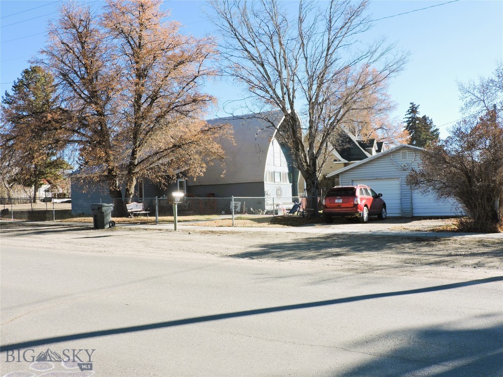 This 1876 SF, 4 BR, 2 bath uniquely designed home has a history in the Ruby Valley and known as the "Prairie Schooner" restaurant near Alder, Montana. It was built in 1965 to replicate the look of a covered wagon but moved sometime in the 1980's or 90's to its current site and remodeled to a family home.  This charming home has lots of natural light, laminate flooring in the living and dining room and features a  large open kitchen, with pantry and  a main level utility area and bedroom. The 804 SF upstairs has an additional 3 bedrooms and full bath for guest or family bedrooms.  The home has been well maintained with new roof, new furnace and new water heater all replaced within the last 3-4 years. There is a fully fenced yard for your fury friends and don't forget the double detached garage which has ample space with benches, concrete floor, insulated and two overhead automatic door openers.