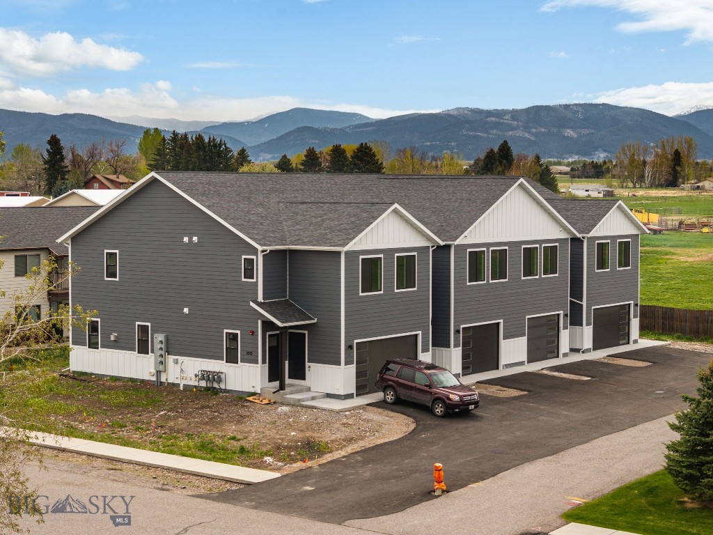 Thoughtfully designed and beautifully finished, this brand-new townhouse in Falcon Hollow offers comfortable living with clean, modern style and mountain views just outside your windows. The open-concept main level creates an inviting space for gathering, featuring warm wood cabinetry, quartz countertops, stainless steel appliances and a spacious island with seating. Large windows bring in abundant natural light while the adjacent dining area flows seamlessly to the patio and backyard space. Upstairs, the huge primary suite offers a peaceful retreat with a dual vanity bathroom, tiled shower, and generous walk-in closet. Two additional bedrooms, a full guest bath, and an upstairs laundry room provide a functional layout designed for everyday living. Additional highlights include vinyl plank flooring, an attached oversized garage, and contemporary finishes throughout. Conveniently located on Bozeman's west side with nearby parks, playgrounds, sidewalks, and easy access to Huffine, this home combines low-maintenance living with modern comfort and style. This home is in the process of being approved for townhome status.