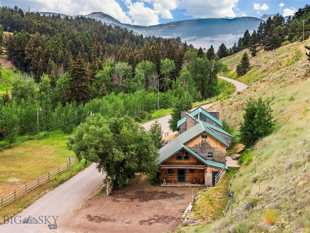 Home with additional rental units in Jardine! Beautiful 1,294 sq ft Log Cabin is fully furnished and ready for immediate rental or as your new primary residence. In addition to the Log Cabin there are 3 Bunk Room rental units, This property offers a rare opportunity to own a unique multi-rental property in Jardine. This location is incredibly desirable, situated just minutes from Gardiner and the North Entrance of Yellowstone National Park, making it ideal for attracting renters or for use as a private residence with income potential. The main Log Cabin features two comfortable bedrooms, a roomy non-conforming sleeping quarters in the attic which currently has two twin beds, two bathrooms, a beautifully updated kitchen, a laundry facility area, and an open family room with a gas fireplace. The 3 Bunk Rooms consist of: Unit 1: One bedroom, one bathroom, a kitchenette, laundry facility hook-ups and a gas fireplace in the living room area. Unit 2: A fully furnished studio with one bedroom, one bath, and a kitchenette. Unit 3: A studio featuring one bedroom, one bath, a kitchenette, and a gas fireplace. While one Bunk Room is fully furnished, the other two await your personal decorative touches. Beyond the living spaces, the property's location is a significant draw. It's situated across from Bear Creek, a tributary of the Yellowstone River, and the area provides endless opportunities for outdoor enthusiasts including hiking, fishing, hunting, and other outdoor activities throughout the year. The sellers have also recently completed a significant upgrade to the property's infrastructure with a brand new septic system installed in July 2025 to accommodate all units. The property also boasts year-round access directly off Jardine Road. We encourage you to experience this beautiful and unique property firsthand. Sellers are motivated!