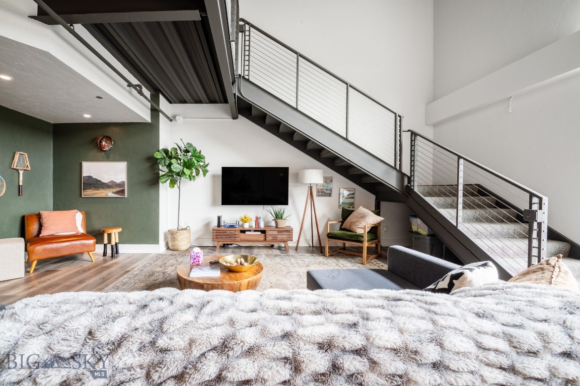 Positioned in a convenient Bozeman location, this thoughtfully designed condo offers a unique blend of modern style and low-maintenance living. With 1,211± square feet, 1 bedroom, and 1 full bath, the space lives large thanks to its open layout, soaring ceilings, and abundant natural light.

The main living area features an airy, contemporary feel with clean finishes and a seamless flow between the kitchen, dining, and living spaces—ideal for both everyday living and entertaining. The kitchen is well-appointed with ample counter space and storage, while large windows bring in natural light throughout the home.

Upstairs, the loft-style bedroom offers privacy while maintaining the open, architectural character of the space. The full bathroom is spacious and functional, and additional storage throughout enhances livability.

Enjoy the ease of condo living with minimal exterior maintenance, plus close proximity to Bozeman amenities, dining, and recreation. Whether you're looking for a primary residence, lock-and-leave lifestyle, or investment opportunity, this property offers flexibility and convenience in a sought-after location.