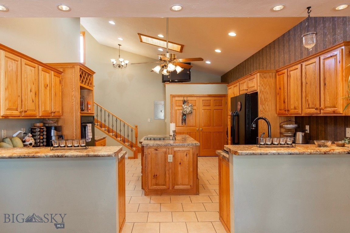 There’s something immediately welcoming about 106 E Hamilton Street—a home that feels comfortable, thoughtfully designed, and easy to live in. Mature trees, a spacious yard, and a covered front porch set the tone, offering a charming place to enjoy your morning coffee or greet neighbors as they pass by. Inside, the bright and airy kitchen serves as the heart of the home, featuring vaulted ceilings, skylights, a large island, abundant oak cabinetry, and generous counter space. Just off the kitchen are a convenient half bath, laundry area, and access to the oversized two-car garage with built-in storage. The dining area flows naturally from the kitchen and opens to the covered front porch through sliding glass doors, making indoor-outdoor living feel effortless. Tucked alongside the dining room, a wood-burning stove adds warmth and character while efficiently heating the main level.  The living room offers ample room to relax or entertain, while the main-floor primary suite provides a private retreat with a recessed ceiling and ensuite bath. Upstairs, two oversized bedrooms filled with natural light share a full bathroom, offering flexible space for guests, family, or a home office. Solid wood trim and doors throughout add timeless warmth and craftsmanship. Ideally located in the heart of Sheridan, this home offers easy access to Downtown, parks, schools, the library, medical facilities, and the community swimming pool—making everyday convenience one of its greatest amenities. With 3 bedrooms, 2.5 bathrooms, and 2,009± square feet of inviting living space, 106 E Hamilton is ready to welcome its next owners. Schedule your showing today and don’t forget to explore the virtual tour.