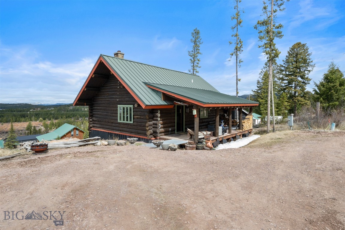 Rustic log cabin on nearly one-half acre with views of lake and surrounding mountains being sold in "as-is" condition.  This all-year residence has 3 bedrooms and 3 bathrooms with full walkout basement and loft above main floor.  Enjoy the wood stove, view deck, open porch and other amenities at this recreation paradise.
