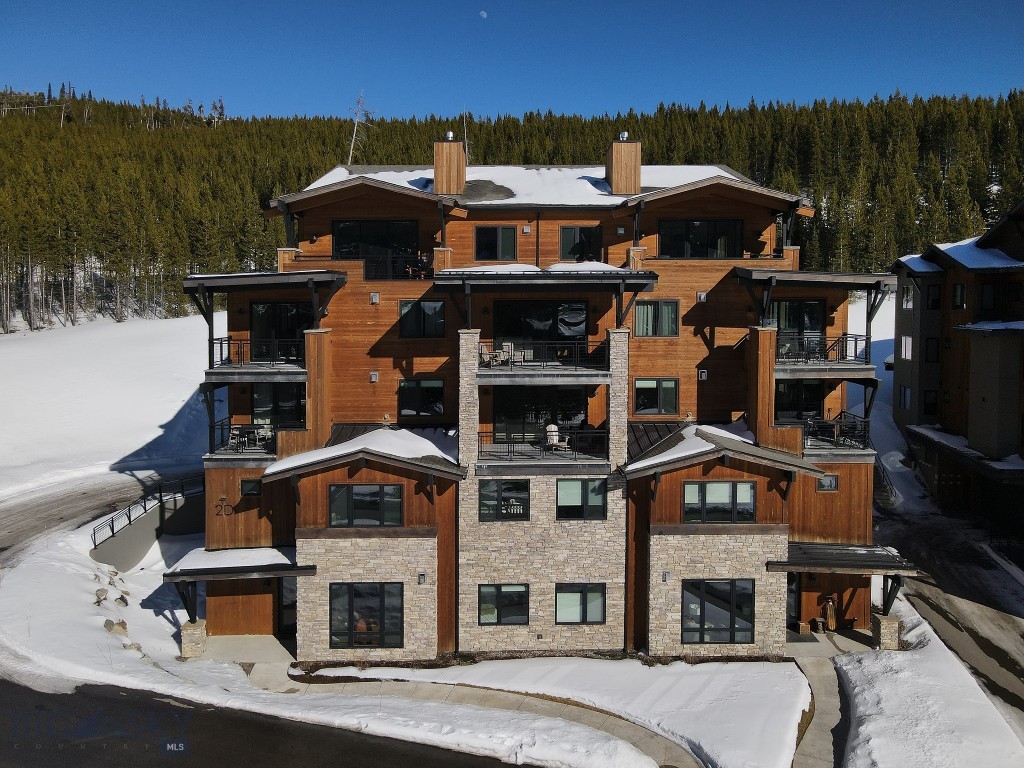 This beautifully appointed 4 bedroom, 3 bath, mountain modern condominium offers effortless comfort and iconic views of Lone Mountain right from your doorstep.
Located on the ground floor, the residence provides easy access and seamless indoor–outdoor living, with expansive windows that frame Lone Mountain in every season — from snow-covered winter mornings to vibrant summer sunsets. Clean architectural lines, warm natural textures, and thoughtfully curated finishes create a refined yet relaxed alpine retreat.
The open-concept living space is designed for gathering, featuring a spacious great room that flows into a well-appointed kitchen and dining area — perfect for entertaining family and friends after a day on the slopes or trails. 
Just steps away, enjoy the Mountain Lake's hot tub, pool, workout facility ideal for unwinding under the big Montana sky.
Whether you’re seeking a full-time residence, mountain getaway, or investment opportunity, this exceptional condominium combines modern design, convenience, and breathtaking Lone Mountain views in one unforgettable setting.