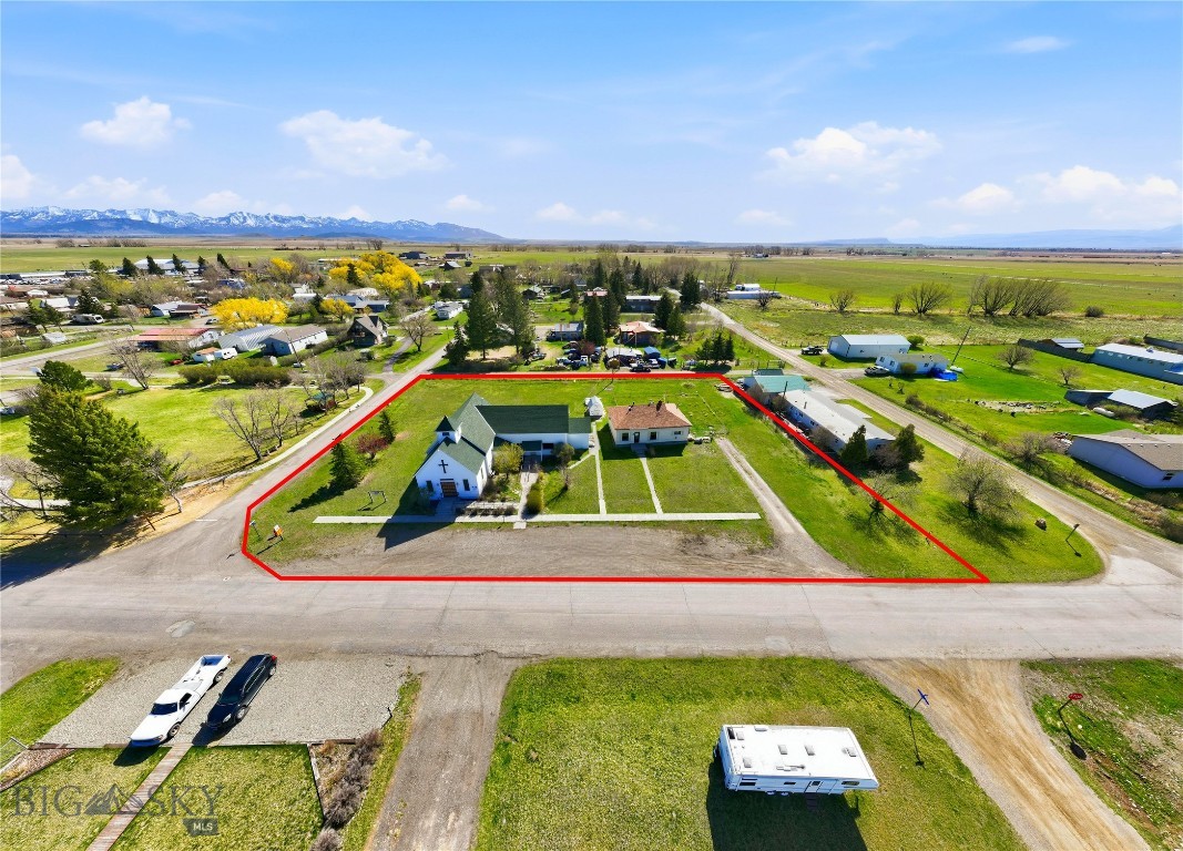 Located in Clyde Park, MT, this legacy property was formerly home to the Shields Valley Methodist Church and includes an additional single-family residence historically used as the parsonage. Situated on nine city lots (0.72 Acres), the ±3,151 SF church building features two large open gathering areas and a kitchen, offering flexibility for a variety of uses. The ±1,120 SF residence includes 2 bedrooms and 1 bathroom. The property is serviced by municipal water from the Town of Clyde Park and an on-site septic system, and is ideally positioned adjacent to Holiday Park. Rich in history and deeply rooted in the community, this unique offering presents a compelling opportunity for both commercial and residential use.