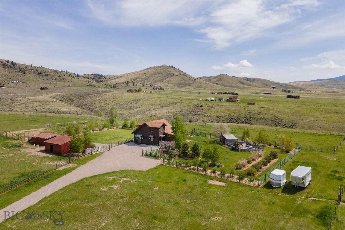 Fabulous, rural living on this 20-acre horse property in McAllister, MT, just north of Ennis. With 360-degree views, sitting at the base of the Tobacco Root Mountains to the west, Centennial Mountains to the south, and the Madison Range to the east, you will find yourself living in a literal paradise. The property is fenced and cross fenced with good grass pastures that will support your horses or other animals all season long. Get your hay, fresh cow and goat milk, and farm raised eggs from your neighbors or raise them right here on your property. Continuous flow stock water tank horse trough to provide year-round drinking water. Power in the barn/shop with lights and outlets. Barns feature metal roofing, hay storage area, and area for animals to eat out of the weather. A second loafing shed with feeders is located nearby for more animals to have shelter. Pastures and rest of the property have been diligently maintained and kept weed free. Additionally, you will find this property to be a gardener's paradise with drip lines installed on all trees and shrubs. This fantastic garden property has 100+ aspen and rocky mountain juniper trees, honey suckle, lilac, other flowering shrubs, blue wisteria, clematis, roses, fruit producing grape vines, hollyhock, sunflowers, wildflower beds, small fruit tree orchard, gazebo, green house, and so much more. The beautifully maintained, two-story home is a perfect fit for this rural retreat. Instant hot water at the kitchen sink, indoor barn doors, hand sawed wood floors, fiber optic lines, F Bertazzonia Italia propane stovetop, 500-gallon propane tank, propane fireplace, pellet stove, foam board insulated septic lines, remodeled bathroom, granite countertops, backup generator, and freshly stained exterior, maximize the comfort level of your rural living experience.