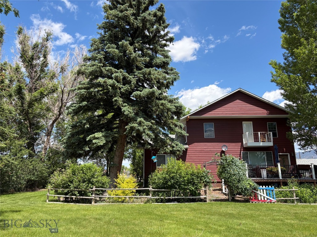 Beautiful ,well cared for home with mature landscaping just out of town. This property  is a garden setting with many mature trees, plantings and flowers. The home was extensively remodeled in 2008. The main house is 2 stories with a wrap around Trex decking porch. The main level has a very large bedroom with a sitting room/office attached. This bedroom is nonconforming (no closet in the bedroom). The floor plan is open with an eat in kitchen, living room and full bath. The 2nd level has 2 bedrooms. One with an attached den/office area . There are 2  baths on the second floor . The laundry and a bonus area are also located on the 2nd floor.
There is a 2 car heated detached garage with a large shop. The property has a finished cottage/ADU with a kitchen.
The ADU was rented for $750 a month. Garden area, raspberry bushes, lots of parking . Plenty of room for chickens, RV , and more. The mature landscaping creates a very private property.
The property does have a Generac System in place. There are so many extras. A MUST SEE.

*** ADDITIONAL PICTURES WILL BE ADDED MONDAY. THE SELLERS ARE IN THE MIDDLE OF DOING SOME CLEAN OUT AND MOVING.***