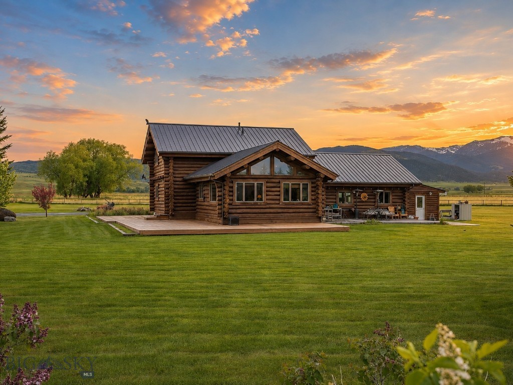 Experience the Montana lifestyle people dream about. Set on 3.76 beautifully maintained acres in McAllister, this log home retreat captures the feeling of a true Madison Valley getaway, with sweeping mountain, rural, and farmland views just minutes from Ennis Lake and the town of Ennis.

Inside, the heart of the home is the expansive great room, where soaring vaulted ceilings, warm log construction, a wet bar, and large windows create the perfect gathering space after a day on the lake, river, trail, or mountain. The kitchen features granite countertops and hickory soft-close cabinetry, offering a comfortable and functional space for hosting family and friends.

The home offers 3 bedrooms, 3 full bathrooms, and 2,885± square feet across two levels with a basement. The lower level adds a relaxed gaming and rec area, giving guests and owners a separate space to unwind, entertain, watch a game, shoot pool, or settle in after a full Montana day.

Outside, the setting is what makes this property shine. A wraparound deck, stamped concrete patio, landscaped yard, perimeter fencing, underground sprinklers, and open green space create a private retreat atmosphere beneath Montana’s wide-open skies.

Whether used as a full-time residence, seasonal escape, or legacy cabin getaway, this property delivers the authentic western lifestyle buyers are searching for.