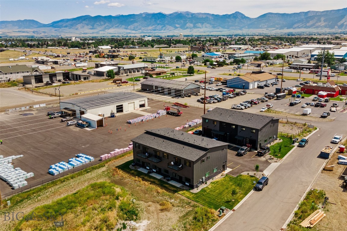 Situated just south of I-90 and west of Jackrabbit Lane on Fletching Way, this newly constructed commercial live/work building offers a rare opportunity to invest in one of the fastest-growing areas in the valley. The property features three thoughtfully designed, mixed-use units that are perfect for owner-users or income-generating tenants. Each unit includes approximately 1,242 square feet of ground-floor commercial/shop space, complete with a 49'-38' x 16' warehouse area, a dedicated office, and a private bathroom. A 12' x 12' overhead door ensures easy access, making the space ideal for light industrial operations, trades professionals, or secure storage. Upstairs, the residential component spans approximately 1,169 square feet and includes two bedrooms, two full bathrooms, a large living and dining room, a well-equipped kitchen with a walk-in pantry, and in-unit laundry. Each unit features a private balcony, providing additional comfort and curb appeal. Whether you’re looking to house your business and live on-site, or seeking a high-demand rental property with dual-income potential, this asset offers strong versatility and long-term upside in an exceptional location.