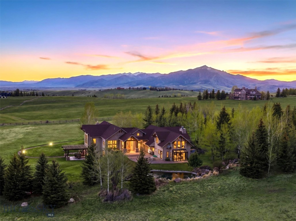 Welcome to Triple Tree Ranch, the most sought after neighborhood in Bozeman. Commanding the landscape from an acre, surrounded by deeded open space on a cul-de-sac, this extraordinary 7288sf, 4B|6B + library and gym property, offers uninterrupted 360-degree panoramas of the valley below, hills in conservation, the Spanish Peaks, Bridger Mountains, Horseshoe Hills, Tobacco Root, and Gallatin Mountain Ranges. Every aspect of this high-quality, Locati designed, end-of-the-road sanctuary exudes rustic elegance, blending gorgeous textures with modern functionality and beautiful finishes. Anchoring the main living area is a floor-to-ceiling stone, wood burning fireplace but the real show stopper is the incredible wrap around walls of glass revealing unforgettable views. Views of nature. Views of mature trees and mountains, animals and your very own private creek meandering down a path of stone boulders spilling into a pond bringing in abundant wildlife. The setting is so private that it couldn't be more stunning or enjoyable. During the winter months you'll love the crackle of a real fire and in-floor radiant heat beneath your feet. In the summer, you'll enjoy the constant flow of cooled air throughout the home and spanning 3 levels with fireplaces on each floor with getaways for entertaining, working out, for study, or just for fun, you’ll never need to leave your sanctuary on the hill. You or your loved ones can’t do stairs? No problem. This home is equipped with an elevator taking you to all 3 levels. If you love to entertain, the seamless transition from kitchen/dining to deck and patio is phenomenal!  You’ll enjoy sitting out on the patio next to the fire pit listening to the creek or melting the day away in your hot tub as you marvel at the incredible views.  If you love growing your own herbs for cooking, the greenhouse/sunroom is like none other! This home is for living the BOZEMAN DREAM.

For the outdoor enthusiast, it doesn’t get much better than living here in Triple Tree Ranch. The trails go forever, and the house is equipped with an enviable gear room to store all your outdoor needs for hiking, climbing, camping, skiing, riding, and hunting, including gun/ammo storage.

While it's obvious you’re set in the country against the mountains, it’s impossible to know you’re only about 7 minutes to Charming Downtown Bozeman. Truly the best of both worlds in this south-side, sought after location.