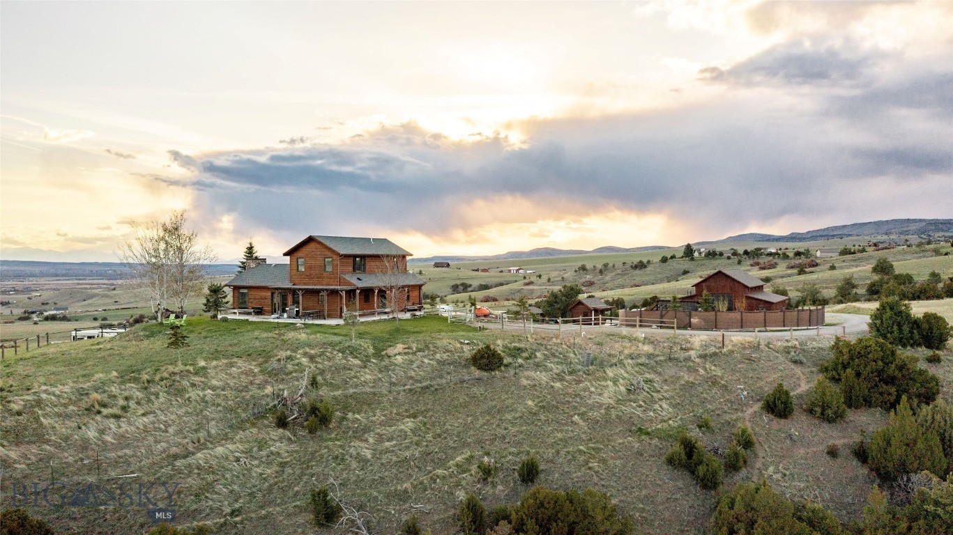 Welcome to this exceptional 21 acre property only 20 minutes from Bozeman, offering privacy, versatility, and breathtaking panoramic valley views. This property includes a single family home, 2 gardens, water house, RV hook-ups, horse/livestock set-up, and brand new shop. The well-maintained home features 3 beds, 2 baths, vaulted main living space, multiple decks/patios, unfinished basement ready for future expansion, and attached heated 2 car garage. Inside, you’ll find quality finishes including Alder doors, trim, and cabinetry, Viking gas range, and comfortable living spaces designed to take advantage of the surrounding landscape. Significant improvements have been made to the property infrastructure, including a fully rebuilt and improved road system for convenient circulation and accommodations for large vehicles/equipment. A standout feature is the newly constructed 50x50 heated shop with in-floor radiant heat, oversized drive-through doors for easy access and functionality. One bay includes roughed-in plumbing and electrical for a future full-size ADU (apartment), with plans for a kitchen and ¾ bathroom positioned with stunning views. With NO covenants or HOA restrictions, this property offers options for investment income, a home-based business, event space, or multi-generational living with flexibility for a variety of uses. Additionally, the property includes a second designated build site with major infrastructure already in place, including a well connection, septic system, and permit-ready preparations for another residence. This creates a rare opportunity for future expansion, investment potential, or the creation of a legacy property. Outdoor enthusiasts and hobby farmers alike will appreciate the flexibility this land and property provide. Bring your horses, livestock, chickens, and gardening dreams — the property already includes two established garden areas, horse and livestock shelters, and ample usable acreage. Adjacent to the property is a protected 1,600-acre ranch under conservation easement, preserving the unobstructed open-space views and enhancing the peaceful setting for years to come. Thoughtfully equipped for hosting overflow guests, there's two full RV hookups with electrical and sewer connections, along with a separate wash house complete with brand-new ¾ shower facilities. This is a truly rare offering combining acreage, infrastructure, flexibility, and unmatched protected views in one remarkable property.