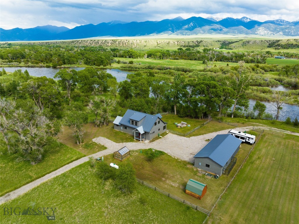 This beautiful private home offers an incredible opportunity for those seeking a nearly riverfront lifestyle. With its modern loft design, spacious interiors, and outdoor amenities, it is perfect for both relaxation and entertaining. The open concept kitchen is designed with painted cabinets, solid surface countertops and a beautifully crafted wood island. Cozy up to the efficient soapstone wood stove on a cool evening in the spacious living room area window facing the River or step outside and entertain guests or enjoy the covered deck and listen to the flowing river water. The Primary main level bedroom is spacious and boasts a beautiful bathroom with a modern double sink vanity and large tiled shower. The loft area has one more private bedroom with a 3/4 shower, and 2 other rooms that can be used as the 3rd bedroom and a workout or office, game or entertainment space. Outdoor buildings include a detached 2 car garage, 3 stall carport, 12'x12' storage shed, and a greenhouse including a heater. Only a narrow strip of Jefferson Acres HOA owned land in between this property and the River as well as to the East. The proximity to the Jefferson River, along with nearby recreational activities, makes it an ideal location for nature enthusiasts. Whether you're looking to enjoy the warmer months fishing, hiking, biking or simply taking in the stunning views of the Tobacco Root Mountains, this property has it all .During the winter months, residents and visitors can enjoy cross-country skiing, snowshoeing, and snowmobiling. While hiking in the area, you may encounter a variety of wildlife, including deer, elk, and moose, which are commonly seen in the Tobacco Root Mountains. Birdwatchers will be delighted by the presence of eagles, hawks, and various songbirds. Additionally, smaller mammals such as foxes, coyotes, and squirrels are often spotted along the trails. Be sure to keep an eye out for unique flora and fauna that thrive in this diverse ecosystem. Furniture/Furnishings are negotiable. Property is in the Floodway.