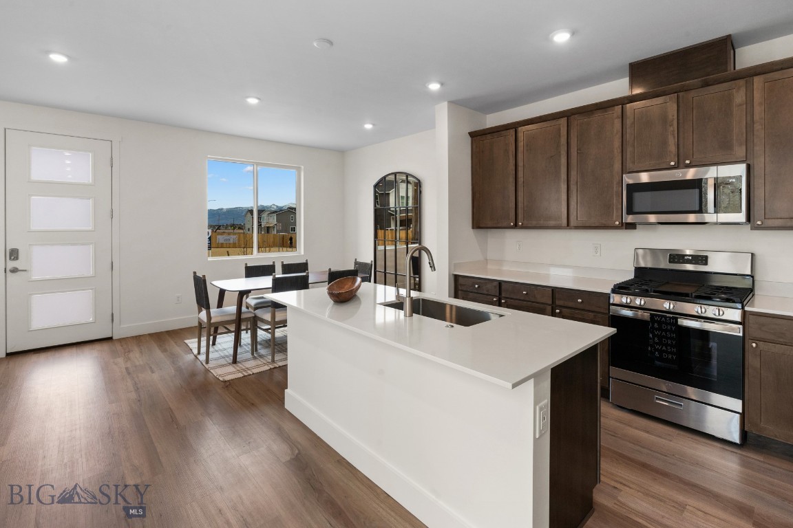 NOW OFFERED WITH BLINDS, WASHER AND DRYER, FRIDGE, AND AC. Welcome to the Jefferson Plan 1 at Northwest Crossing a 3-bedroom, 2.5-bath townhome designed for easy, low-maintenance living so you can spend more time exploring Montana. The open kitchen, dining, and family room create a bright, inviting space with quartz countertops, stainless appliances, and plenty of natural light. Enjoy your morning coffee on the covered porch and the convenience of a two-car garage. Upstairs, the primary suite with walk-in closet is paired with two additional bedrooms. Living here means walkable access to local shops, dining, and green spaces, plus quick trips to Bridger Bowl, Big Sky, and downtown Bozeman. Comfort, convenience, and adventure all in one place.