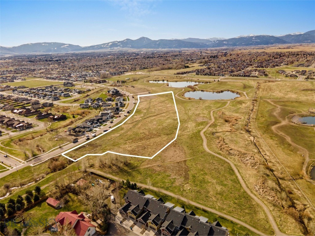 An exceptional 7-acre development opportunity located within city limits and directly across from The Crossing neighborhood. This fully entitled, shovel-ready project is approved for 44 townhomes, presenting a rare chance to deliver much-needed housing in one of the area’s most desirable and rapidly growing corridors.  Bordering the expansive 100-acre Gallatin County Regional Park, the property offers panoramic mountain views, ideal southern exposure, and immediate access to trails, open space, and recreation. The premier park-adjacent setting combined with in-town convenience creates outstanding value and long-term appeal for this development.  With approvals secured and development-ready status in place, builders and investors can step confidently into a thoughtfully planned project—without the delays, risk, and uncertainty of the entitlement process.