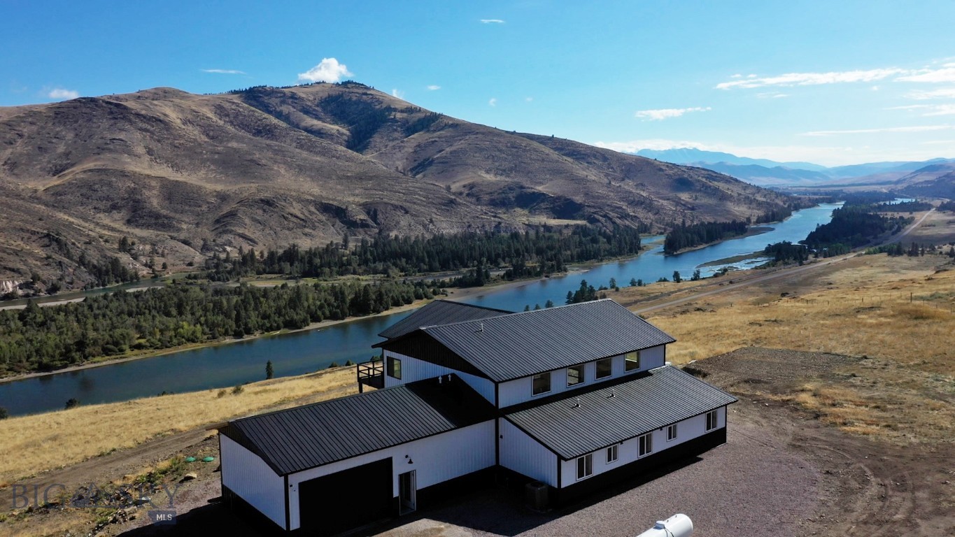 The luxurious Montana dream property called Flathead River Ranch has 360-degree panoramic views perched on 39± acres that borders acres of preserve land. Flathead River flows through the majestic valley below with views of far-off peaks surrounding the property. The new construction home offers the ultimate in animal life, with full view of the Ferry Basin Elk preserve, and wild horses grazing through reservation land. This unique and pristine property is secluded yet accessible by vehicle or helicopter via your own helipad (virtual imaging for the helipad). Year-round living is easily accessible with the use of a snowplow. Enjoy hunting, fishing and many forms of wildlife and outdoor activities from your doorstep (permits required for access to reservation land). This mountain top home has been completed with self-sustainability in mind; solar, generator and private well. The house and its systems are self-contained power with the primary source being solar. The main house has three bedrooms, two-and-a-half bathrooms, high-end finishes with a spacious open floor plan. The chef’s kitchen, cozy fireplace, upper-level loft & wet bar offer captivating views as life outside comes inside through the expansive balcony. The home was designed to soak in breathtaking views in every direction. This one-of-a-kind property has designs in place should you want to add a 3/2 guest house and/or a 2/1 cabin. All septic and wells are in place including a RV slip and vast amount of parking for boats and snowmobiles. Whether you’re looking for a primary getaway residence or a vacation getaway, this property offers everything you need and more. Property also comes with a transferable lease of a 30’ boat slip on Flathead Lake 30± miles away. Local boat ramp 3± miles down the road to jump on the Flathead River. Let us introduce the most incredible property, home and awesome views to you in person or thru our virtual and drone tours of the home and land. Don’t miss this rare opportunity!