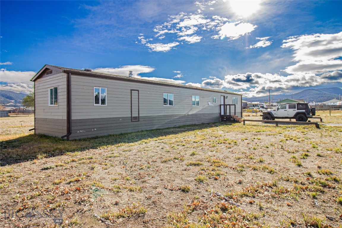 This 1977 manufactured home is on a permanent foundation and has been updated with new paint, new flooring, furnace, windows, and some wiring and plumbing.  The main living area feels spacious with a raised living room and a dinette table that fits the space perfectly.  The kitchen has ample cabinet space and you will love the view out of your kitchen window!  There are sliding doors to the back deck, and the 1 acre property feels expansive and private.  All 3 rooms are nicely sized with closets, and the bathroom and laundry are located right next to the master.  The property shares a well with the neighbors but has a private septic system.  There are also underground sprinklers, though the seller is unsure if they work.  There is a shed that comes with the property as well.  A home with acreage for under $300k!  Don't miss this opportunity!