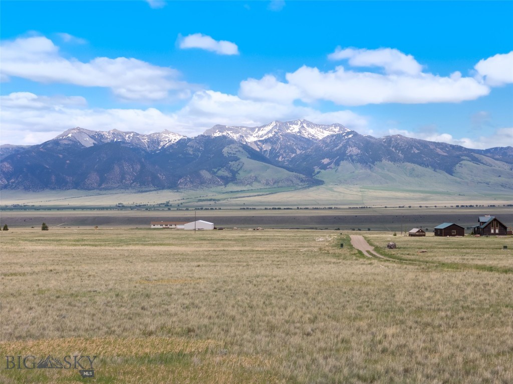Located on a desirable corner lot at the intersection of Stage Coach Trail and Chipmunk Trail, this nearly 7-acre parcel in the scenic Shining Mountains Neighborhood offers a unique opportunity to create your Montana retreat with multiple access points and exceptional flexibility for home placement.
The property features numerous level building sites, allowing you to frame the panoramic mountain views from virtually any angle. Whether you're envisioning a rustic cabin or a modern ranch-style home, this lot provides the space and setting to bring your vision to life.
With fiber optic and power available in the area, you can enjoy modern connectivity without sacrificing the peace and beauty of the Montana landscape. With easy access from Hwy 287 and Varney Bridge, this parcel is just 20 minutes from Ennis and one hour from Bozeman Yellowstone International Airport. Outdoor recreation is close at hand, with nearby access to hiking trails, alpine lakes, the renowned Madison River, premium Blue Ribbon trout fishing, and prime hunting grounds.
Experience wide-open skies, sweeping vistas, and endless potential—this is Montana living at its best.