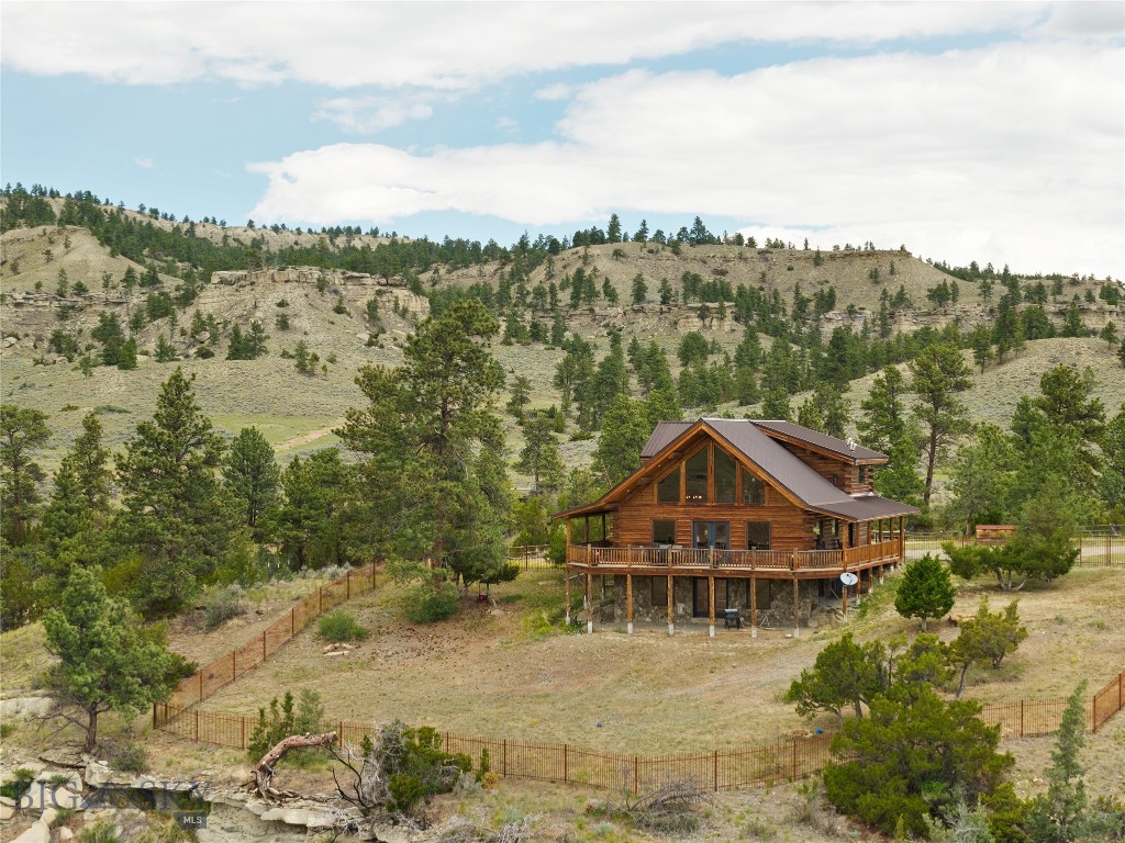Experience the ultimate Montana ranch lifestyle at this beautiful end of the road property. This high-end 3-bedroom, 2-bathroom log home sits on 160 breathtaking acres of rolling terrain with views that will stop you in your tracks. Inside, the gourmet kitchen boasts quartz countertops, wood cabinetry, and stainless appliances. Step onto the partially covered wrap-around deck and let Montana's big sky do the rest. The walk-out basement is partially finished, offering excellent potential for additional living space. A brand-new 54x84 steel framed shop/barn combo with concrete flooring in half the structure stands ready for equipment or livestock. Water is well-covered with two seasonal reservoirs and a dedicated livestock spring. Whether you're dreaming of a working ranch, equestrian estate, or a private luxury retreat, this Park City property delivers it all.