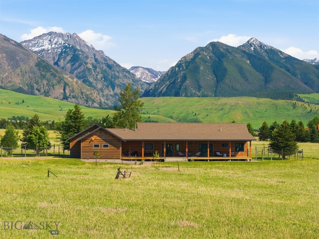Custom, single level, ranch-style home offers sophisticated living on an easy-care one-acre lot within the prestigious Jumping Rainbow Ranch. Located just ten minutes south of Livingston, Montana, this property is tailor-made for discerning buyers seeking an elevated mountain lifestyle, without the need to own and care for multiple acres, yet you have the ability to enjoy 160 acres of dedicated open space, and private community walking access to the celebrated Yellowstone River. A meticulous full-scale renovation in 2023 shines throughout the home, highlighting refinished, original hewn hardwood floors, custom built-ins, new Pozzi windows and doors with premium coverings, and abundant natural light paired with new recessed lighting and ceiling fans. The showpiece kitchen is a chef’s dream, featuring a spacious pantry, new stainless steel appliances, an in-countertop five-burner downdraft cooktop, wall and convection ovens, and a built-in wine refrigerator. In the living room, a cozy gas stove is anchored by a striking, floor-to-ceiling soapstone accent wall, and expansive windows that capture the stunning Absaroka Mountain range. The primary suite serves as a private sanctuary, opening to a secluded deck perfect for relaxing with a morning cup of coffee while soaking in a mountain view that only Paradise Valley can deliver. The space flows into a spa-like bathroom complete with an oversized shower, classic clawfoot tub, and a private bidet equipped, toilet closet. There is a walk-in closet with custom built-ins to make the most of every inch of space. The 2nd bedroom has a walk-out door to the covered west deck. A versatile dedicated office easily transitions into a third bedroom. The 2nd bathroom is tiled with a walk-in shower and bidet toilet. Efficient mini-split systems and in-floor radiant heat ensure tailored year-round comfort. The exterior showcases classic wood siding with fresh chinking, custom garden gates that protect a beautifully manicured yard, a paved walkway, and welcoming covered porches. The landscaped grounds are framed by mature aspens and fragrant lilacs, all maintained by an underground sprinkler system. The 3 bay garage has both heated and unheated options and enters directly into a large laundry/mudroom. Designed for those who appreciate refined single level living, Paradise Valley delivers the most spectacular lifestyle imaginable—putting world-class fishing, hiking, and wildlife right at your doorstep. Legacy living, refined.