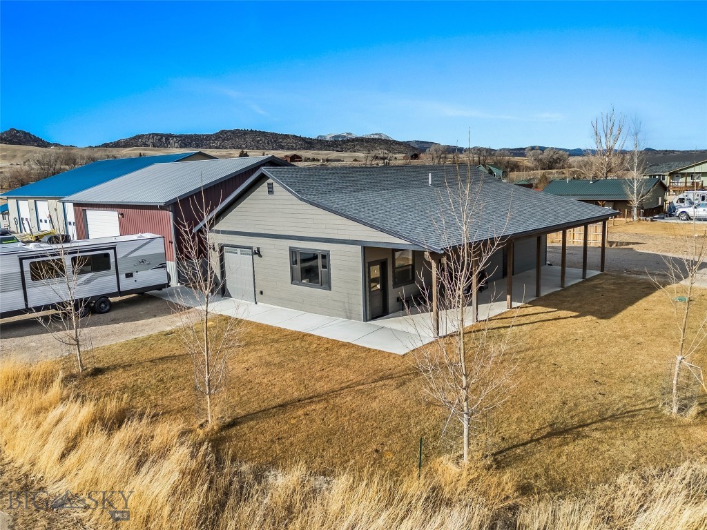 One-of-a-Kind Live/Work Property in Ennis, Montana. Opportunities like this rarely come along in Ennis. This exceptional commercial/residential property offers the ultimate live-work setup, investment potential, or business headquarters with no other property currently on the market quite like it. The 40’ x 40’ fully insulated metal shop features 14’ walls, a 12’ x 16’ overhead door, and is built to perform. The shop includes a 16’ x 18’ office with electric baseboard heat, a kitchenette, and a ½ bath. It is plumbed and prepped for radiant floor heat (boiler needed) and currently heated with a wood stove. Construction highlights include spray-foam insulated walls, blown-in ceiling insulation, a full metal exterior and roof, plus a storage mezzanine for added functionality.
Outside, you’ll find 30 & 50 amp RV hookups with dump, along with ample extra parking ideal for equipment, trailers, work vehicles, or recreational toys. Next to the shop sits a beautifully built 2023 home offering 1,224 sq ft, 3 bedrooms, and 2 bathrooms. The home features granite countertops, alder cabinetry in the kitchen and baths, and tasteful modern finishes throughout. The primary bedroom is generously sized with an ensuite bath showcasing a custom tile shower. Additional features include an on-demand water heater, forced-air propane heat, central air conditioning, and a landscaped yard with underground sprinklers. This versatile property opens the door to endless possibilities like a live/work operation, contractor or trades headquarters, automotive, fabrication, or equipment shop, storage and rental income, short or long-term residential rental, business with on-site owner housing, recreational basecamp for RVs, boats, and gear. Located in the heart of Ennis, you’re minutes from world-class fly fishing on the Madison River, with easy access to hunting, hiking, horseback riding, snowmobiling, and public lands in every direction. Ennis offers a vibrant small-town atmosphere with stunning mountain views and endless outdoor recreation. Unique, flexible, and impossible to replicate, this is a rare Ennis offering you don’t want to miss.