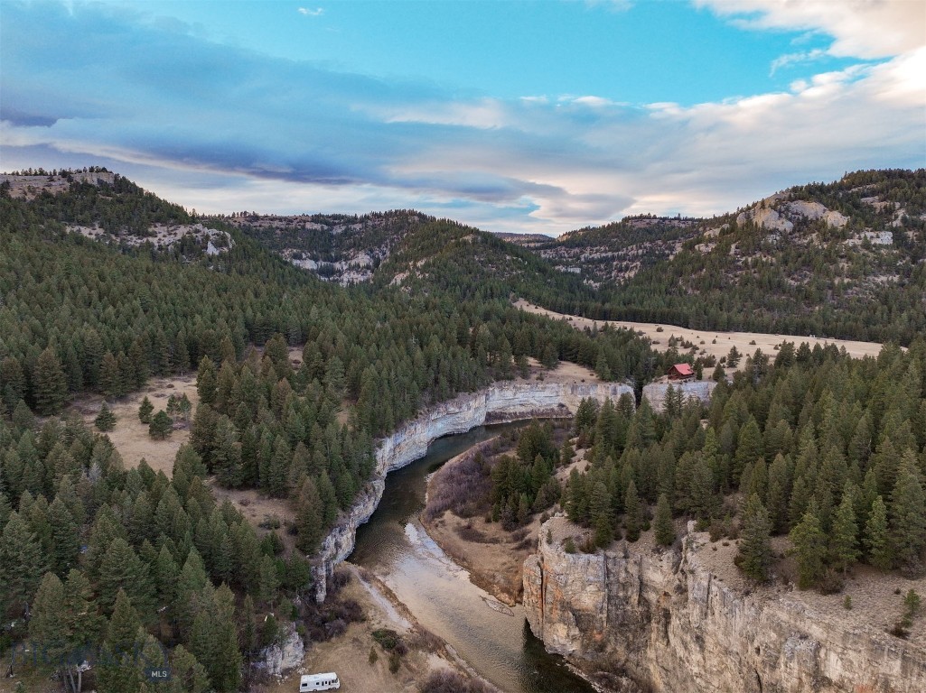 This is a rare opportunity to purchase almost 30 acres in the cabin sites community that shares access to the coveted Smith River. While the public has to apply for permits, that have a quota, if you own a piece of property behind the locked gate, you can day-float the river about as often as you’d like. What is also particularly attractive is that most of the lots in the community are quite small. This generously-sized 30 acres is a blank slate for your development plans. There are nice building spots that take in the stunning canyon and river views, covered in mature trees offering privacy and shade, plus there are 1000’s of acres of Forest Service ground on the other side of the river. Keep the trees or cut and open up even more river and canyon views. With deeded access to the river, privacy, trees, nearby public ground and plenty of room to build this is what defines a true LEGACY ESTATE. Simple protective covenants. No electricity, well or septic currently in place.  
Buyers should understand the floating rules administered by FWP.