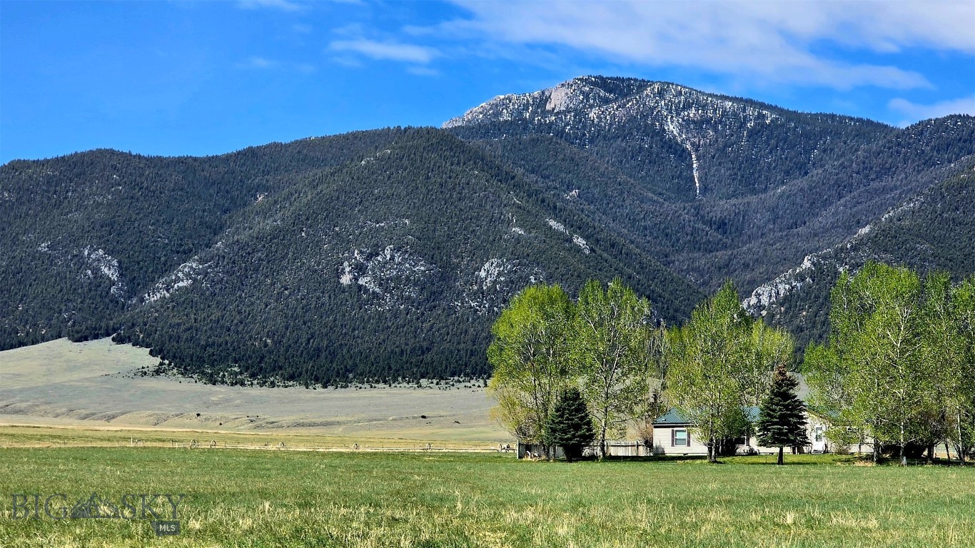 Rare opportunity to own 37 productive acres featuring early priority water rights, established agricultural use, and an end-of-road setting with breathtaking, unobstructed views of the Ruby River corridor, Tobacco Root Mountains, Gravelly Range, and Ruby Mountain Range — a setting that simply cannot be replicated. Wildlife abounds, with local deer frequently seen throughout the property, adding to the peaceful Montana landscape. Located near the historic town of Alder, Montana — the gateway to the Upper Ruby River and Snowcrest Mountains — this property offers exceptional access to year-round recreation, including world-class fishing, floating, boating and water sports on the reservoir, camping, snowmobiling, and winter ice fishing. Public fishing access on the Ruby River is just minutes away. This versatile property combines productive acreage, open space, and outstanding rural lifestyle amenities. A greenhouse offers year-round organic gardening opportunities, while the horse corral and fenced pastures make the property ideally suited for livestock, equestrian living, or hobby farming. Additional improvements include a 2,040-square-foot de-titled* Fleetwood home, two yard sheds, and a large outbuilding with four livestock stalls, along with ample storage for hay, equipment, or recreational vehicles. Valuable early priority water rights enhance the property’s agricultural appeal, with gravity-fed irrigation delivered through wheel lines and hand lines, all included in the sale. The property is currently irrigated and farmed under an existing agricultural arrangement through October 2026 with a nearby ranch. Whether you are seeking a productive investment property, future homesite, working ranch expansion, or peaceful country retreat, this exceptional offering combines productive farmland, valuable water resources, abundant recreation, and unmatched scenic beauty in one remarkable Montana property.