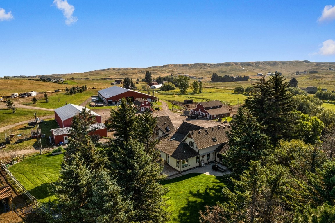 This property is a dream for horse enthusiasts and the perfect small ranch operation. If you've been looking for a property that has it all, this is it!! Settled amongst Camp Creek, cottonwoods, lush farm land and stunning views, this premier equestrian estate on 96± deeded acres in Gallatin Valley is just 15 minutes from Manhattan & Belgrade, or 25 minutes from Bozeman. This unique offering features a 4900+/- SF home (prepped for remodel), extensive horse facilities, productive irrigated ground, and Camp Creek meandering through the property. The ranch includes 40± acres of wheel-line irrigated fields, 49± acres of native pasture, and 10± acres of improvements. Amenities include an expansive indoor riding arena, indoor/outdoor boarding facility, tack room, outdoor arena, ample hay storage, two historic barns, machine & equipment shops, a gym and "trophy" space, and well-designed paddocks. The ranch previously supported a boarding operation and yields about 200 tons of grass/alfalfa hay annually. The main home, originally a historic farmhouse, was renovated in 2011 with a large addition. The home is currently in a “ready to remodel” condition, and now sheetrocked & taped. Original cabinets, vanities, counters and trim are left on site for the next Buyer, reducing cost of completion. Bring your vision to make it your own! 40 Shares of Low Line Canal are included for irrigation. With rural views of the Spanish Peaks and Bridger Mountains, mature trees, creekside and an irrigated backyard oasis, this productive ranch offers the perfect blend of function, beauty, and potential in one of Montana’s most desirable locations. Some interior images are AI images to assist with "remodel vision." Sheet rock and taping will be completed, then home and property is to be sold as-is. Photos of the home prior to demo can be shared upon request.