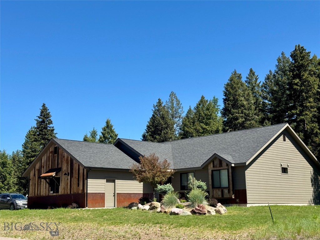 Silvertip Trailhead is a newer custom built 1,743 square foot home in Seeley Lake’s new mountain outdoor and trail-oriented community of Alpine Trails. 3-bedroom, 2 bath, open floor plan with luxury vinyl plank flooring, vaulted ceilings and lots of big windows for natural light. The kitchen is finished with black stainless-steel appliances, quartz countertops, breakfast bar, pantry & custom European knotty alder cabinets in a charcoal color. Sliding glass doors off the dining area flow out to the stamped concrete patio. Off the kitchen is the family entry with a built in bench, a dedicated laundry room and access to the finished 2 car garage plus a UTV garage lock off. The master suite has the comfort and warmth of carpet, vaulted ceiling, and a barn door to access the master bath finished with porcelain tile, Corona countertop, and a stand-alone soaking tub. The outdoor area is sprinklered. If you seek a part time recreation home with income and investment possibilities, short-term rentals are permitted, this home is enrolled through August and offered turn-key. Access hiking and cross-country ski trails out your door and ride directly to groomed snowmobile trails. Located on walking trails that will take you to nearby restaurants, taverns, shopping and music throughout the recreational mountain town of Seeley Lake.