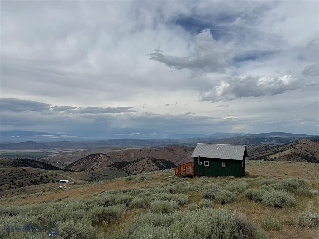 Top-of-the-World Tranquility 357 Pole Gulch Road | Three Forks, MT Now Offered at $225,000 | 10.012 Acres | 2023 Build | Off-Grid Studio Cabin Discover unmatched privacy and serenity at this mountaintop retreat tucked deep within the Ponderosa Pines. Perched high above the valley floor, this brand-new cabin captures sweeping panoramic views and offers the peaceful escape so many dream of—but rarely find. Located farther back in the subdivision, this property is ideal for someone truly seeking solitude, off-grid living, and the kind of privacy where neighbors are few and far between. Completed in 2023 and never occupied, this off-grid studio cabin features a bright open-concept layout with a full kitchen, full bath with a composting toilet, and a cozy living area anchored by a wood-burning stove. Propane appliances make everyday living simple, while the 500-gallon water tank adds convenience for those seeking a low-maintenance, sustainable lifestyle. Set on over 10 acres of untouched Montana land, the property offers incredible flexibility for the next owner. No well or septic is currently installed, allowing buyers to create a setup that fits their vision. The seller did obtain well and septic quotes several years ago, and if a buyer would like additional information, we’re happy to connect them with a trusted local company for updated guidance. Step outside onto the spacious front porch and take in endless sunrises, glowing sunsets, and the quiet rustle of the surrounding pines. Here, you’ll feel completely removed from the hustle of daily life—yet still conveniently located just 35 minutes from Three Forks, 45 minutes to Bozeman Yellowstone International Airport, 1 hour to downtown Bozeman, 1 hour and 10 minutes to Bridger Bowl, and 1 hour and 30 minutes to Big Sky Resort. Outdoor enthusiasts will love the proximity to world-class fishing, excellent hunting throughout Three Forks and the surrounding area, plus endless hiking and recreation opportunities. Whether you’re after solitude, adventure, or a private off-grid basecamp, this property delivers. Recently reduced to $225,000, this is an exceptional opportunity for the right buyer looking to unplug, spread out, and own a truly peaceful slice of Montana wilderness.