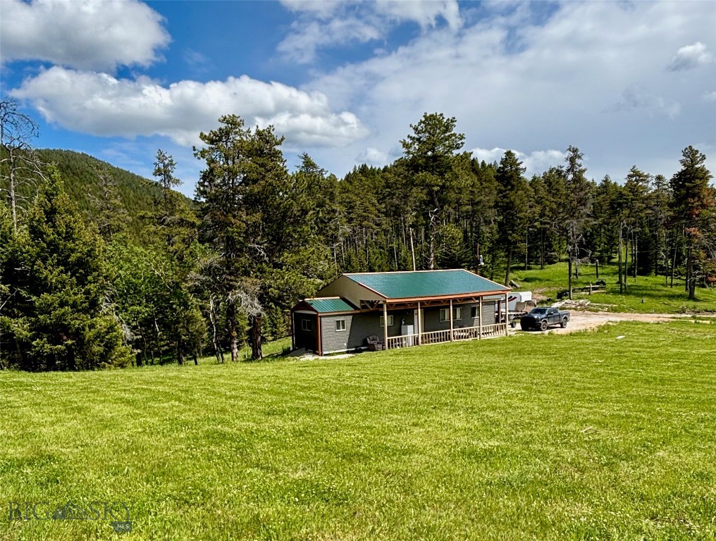 Mountain land for sale in the heart of the Judith Mountains near Lewistown, this 50± acre offering combines two parcels (A & B) into one highly functional hunting and recreational property located in the renowned Game Management Unit 412. Positioned at the junction of Maiden Road and Judith Peak Road the property offers excellent access while still maintaining privacy and direct proximity to thousands of acres of public land.

The landscape is a diverse mix of open grazing and timbered mountain terrain, creating ideal habitat for elk, deer, bear, moose, and mountain lions. With significant stands of marketable timber, the property provides both immediate usability and long-term value. Water is a standout feature, with a well, natural springs, and Maiden Creek (water right included) running through Parcel B

Improvements make this a true turnkey basecamp or mountain retreat. The property includes a 720 sq ft, 2-bedroom, 1-bath furnished cabin, complemented by a 400 sq ft covered front and back porch, perfect for enjoying the surrounding views. Additional infrastructure includes two conex storage units, a 12x40 workshop shed, and a trailer-mounted sawmill capable of handling 30" x 16