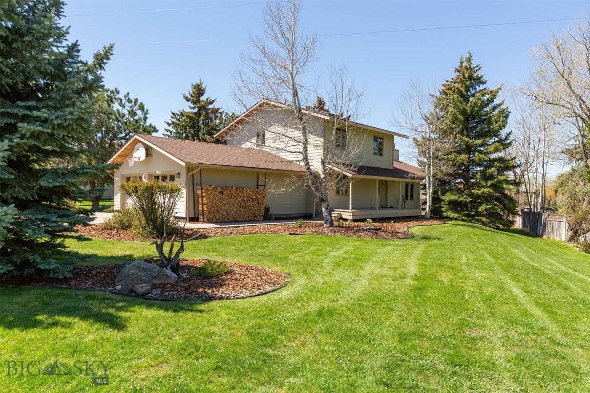 Don't miss this special southside property with over 200 feet of enchanting Limestone Creek frontage.  This one acre property offers a rare opportunity to enjoy the sights and sounds of true Montana serenity while adding your own vision and updates over time. Cottonwoods, willows, mature landscaping, abundant birdlife, and the soothing flow of the creek create an unforgettable backdrop for this spacious 3,291 sq ft home. Spend your days listening to sandhill cranes overhead, relaxing beside the babbling stream, or gathering beneath the shade of a grand cottonwood tree at the creekside picnic area. The sunny backyard is a gardener’s paradise, complete with a large productive garden, thriving raspberry patch, and peaceful views of nearby Limestone Pond. Built in 1978, the home has solid bones while also offering tremendous opportunity for cosmetic updates and personalization. Inside, the expansive great room centers around a cozy wood fireplace framed by custom built-ins, and offers ample space for both formal and informal living.  A covered deck extends the living space outdoors, creating the perfect setting for entertaining or simply soaking in the tranquil surroundings. The kitchen is ready for your creative touch to modernize and make it your own. The main level also features a sitting room, bedroom, ¾ bath, and convenient utility/mud room off the attached double garage. Upstairs, you’ll find three bedrooms and a full bath, including a spacious primary suite with walk-in closet and private balcony overlooking Limestone Pond—an ideal retreat for quiet mornings and sunset evenings. The lower level provides exceptional flexibility with a family room, full bath, extra room, and extensive unfinished space with a separate entrance, ready to become a media room, gym, workshop, or additional living area. A whimsical hidden feature known as the “Elephant Room” adds future potential for expanded walk-out access to the irresistible backyard and creekside landscape. Rarely does a property combine extensive creek frontage, wildlife habitat, and such incredible potential in one truly magical setting. This is a home where the natural surroundings are already extraordinary—and the next owner has the opportunity to thoughtfully update and create something truly exceptional.