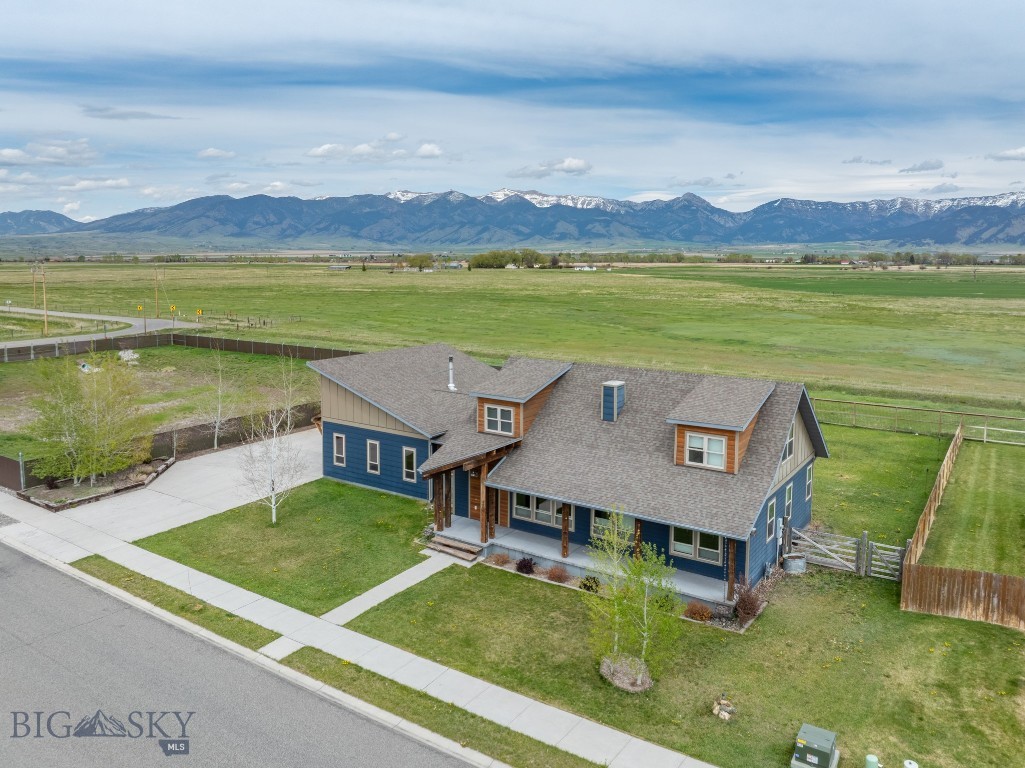 Open space views are hard to come by in the Gallatin Valley. This view shed of the Bridger mountains looking across an open farm field is sure to please. This 2016 build sits on almost a half acre (.46+/- ac) and with no neighbors on two sides. The yard is fully fenced, offers a large covered front porch and spacious concrete driveway to the 3 car garage/shop. This home was designed and built with the 875+/- sq ft garage dedicated as a attached shop space. The tall ceilings in the garage offer loft space, the walls/ceiling have been spray foamed and it even offers a large wood stove. If you have ever dreamed of a large shop/garage attached to your home then you need to see this. The home offers a functional layout with main level master, open kitchen/living room, second bedroom, full bath and a dedicated dining room with doors to the backyard. There is one additional bedroom and a full bath upstairs. This home is located on the North end of Ryen Glenn sundivision and offers the convenience of quick access to both Penwell to Springhill or Penwell to Dry Creek Rd. This is home is an understated combination of functional design and a serene setting.