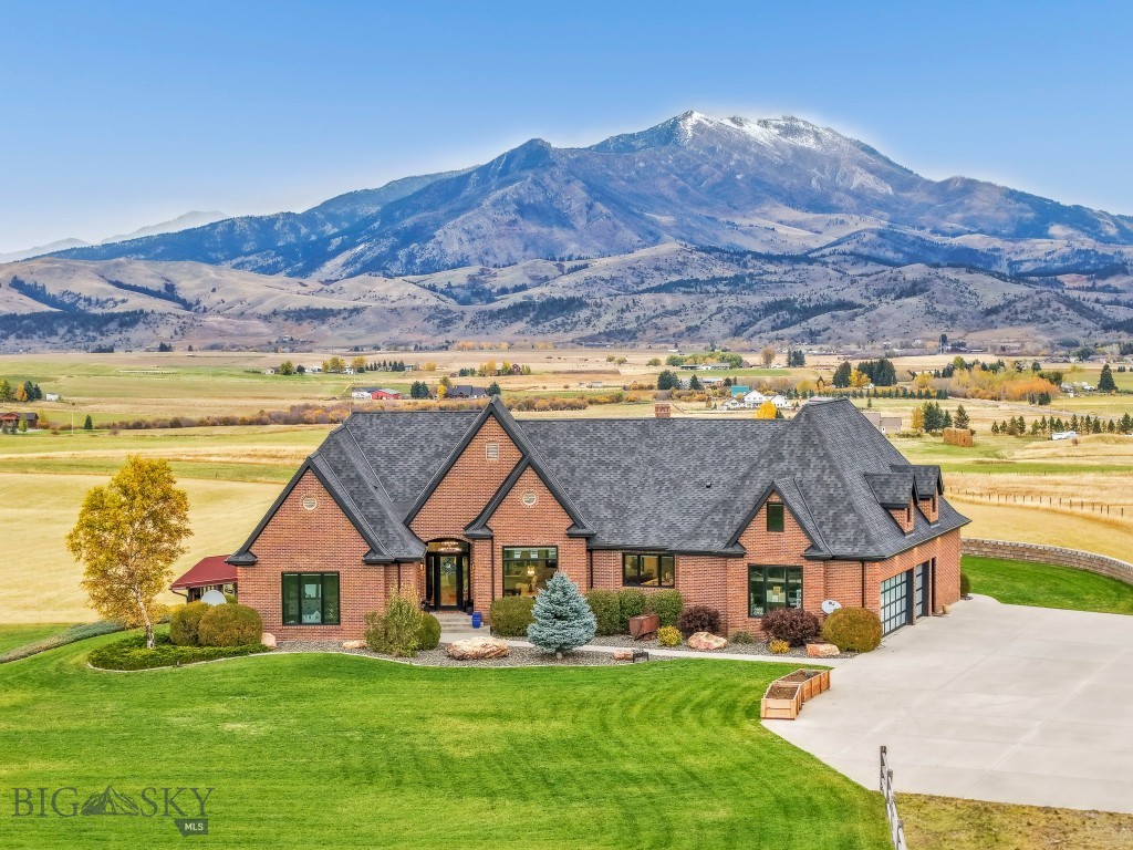 Welcome to 2375 Mount Ellis Lane, where modern mountain luxury meets Montana tranquility. Perched on 20 acres and backing directly to state land, this stunning 6,286-square-foot estate was originally built in 1995 and completely transformed between 2022–2023. Every inch has been thoughtfully redesigned with craftsmanship and comfort in mind. The home features 5 bedrooms, 5.5 bathrooms, and a bunk room, along with a chef’s kitchen fitted with all-new appliances and designer finishes. Expansive living spaces capture panoramic views through brand-new windows and open seamlessly to the outdoors. Wellness and recreation are built into the design from the state-of-the-art gym with awe-inspiring mountain views to the indoor basketball court, sauna, and SwimEx pool. After a workout, unwind in the outdoor hot tub and soak in the beauty of the surrounding landscape. Additional upgrades include a new roof, new windows, garage doors, real wood flooring, exterior doors, appliances, landscaping, asphalt driveway, and an EV charging station. Offering unmatched privacy, luxury, and connection to nature all within minutes of downtown Bozeman this home truly embodies the best of Montana living.