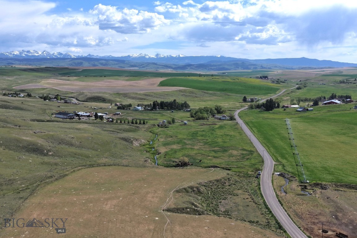 Located just south of the town of Amsterdam, this incredible 20-acre property offers a rare opportunity to own a piece of paradise in the Gallatin Valley.  Camp Creek runs through the property, providing a serene water feature and a natural wildlife corridor. With no known covenants, this property offers unparalleled freedom for your vision, whether you intend to build a dream home, create a recreational retreat, or hold the land as a long-term investment. 
The property is situated just steps away from 154 acres of state land, providing additional space for exploration, privacy, and hunting. Potential homesites offer panoramic views of the Spanish Peaks and Bridger Mountains, while the view to the west is protected by a conservation easement covering over 700 acres of farmland. Legacy parcels featuring live water, mountain views, and access to public land, all while remaining close to the modern conveniences of Bozeman and Belgrade, are increasingly hard to find. Do not miss this chance to own a remarkable property in one of Montana's most sought-after areas.