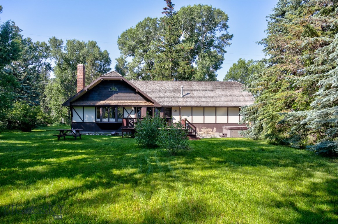 This is a charming 4-bedroom, 2-bathroom home located on Ninth Street Island Drive, a beautiful and unique location surrounded by mature trees and spread across an area of 1.624 acres. The house is situated right in the heart of nature, attracting moose, deer, and a variety of songbirds, creating a private and peaceful woodland setting. The house's surrounding trees provide ample shade, keeping it cool during hot summer months, while the stone fireplace inside makes it cozy during the chilly winter nights. The house features an open floor plan, which gives it a spacious and airy feel, making it perfect for hosting gatherings with family and friends. The kitchen has been remodeled, boasting modern appliances and ample counter space for easy meal preparation. The whole-house humidifier ensures that the air stays comfortable all year round. You'll love the several window seats that offer a stunning view of the backyard, where you can relax and enjoy the tranquility of nature. The 24' x 24' attic space provides additional storage above the garage. The great room walls are decorated naturally with an American Clay wall finish, giving it a unique and rustic charm. Despite its rural feel, the property is conveniently located within walking distance of Livingston's historic downtown and Sacajawea Park, where you can enjoy shopping, dining, and outdoor activities. Owning this property is a rare opportunity to live on the Yellowstone River's only inhabited island, providing you with a unique and tranquil lifestyle that is hard to find anywhere else